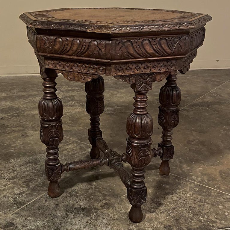Antique Renaissance octagonal end table was fashioned from solid oak, and features carved detail from the surface to the teardrop feet! Octagonal top is lavished with gadrooned edges and foliate carvings, supported by a finely carved 8 section