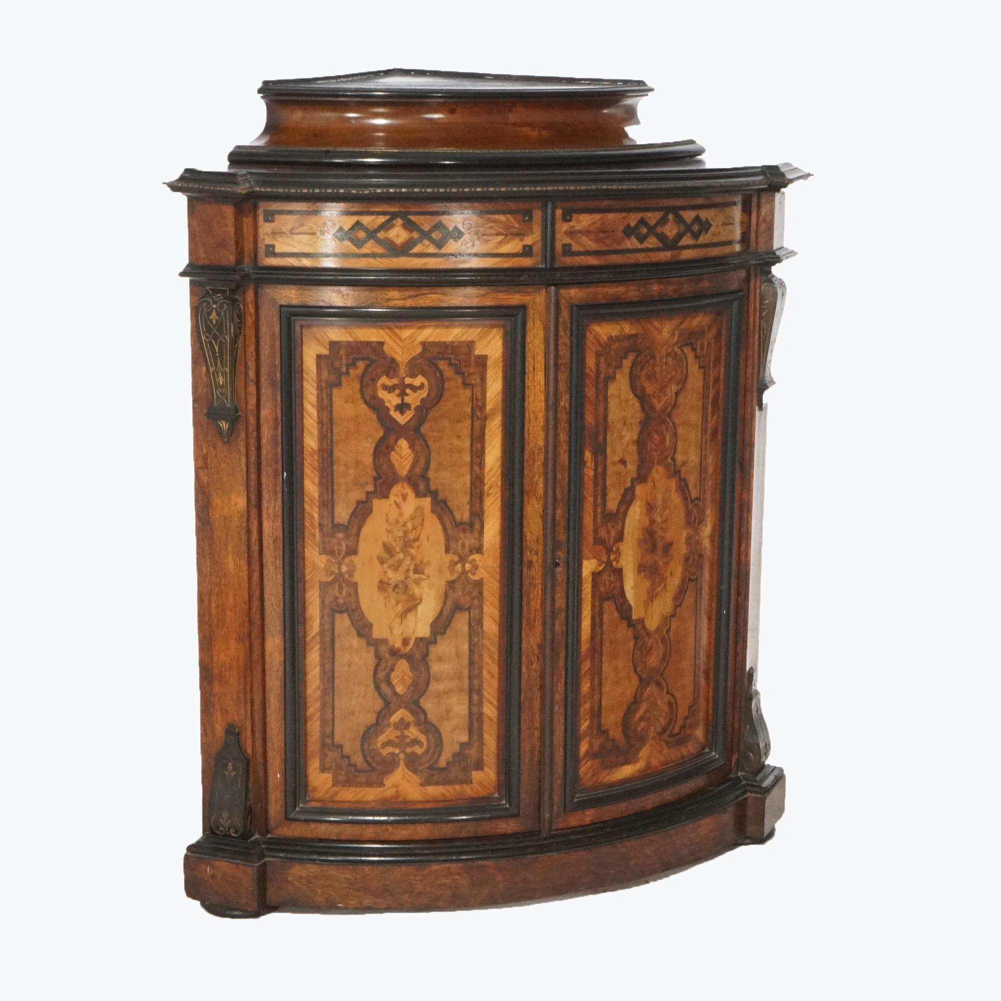 An antique Renaissance Revival Aesthetic corner cabinet offers rosewood construction with stepped display over double door case with shelved interior, marquetry decoration, and carved elements, c1880.

Measures- 43.25''H x 36''W x 25''D.