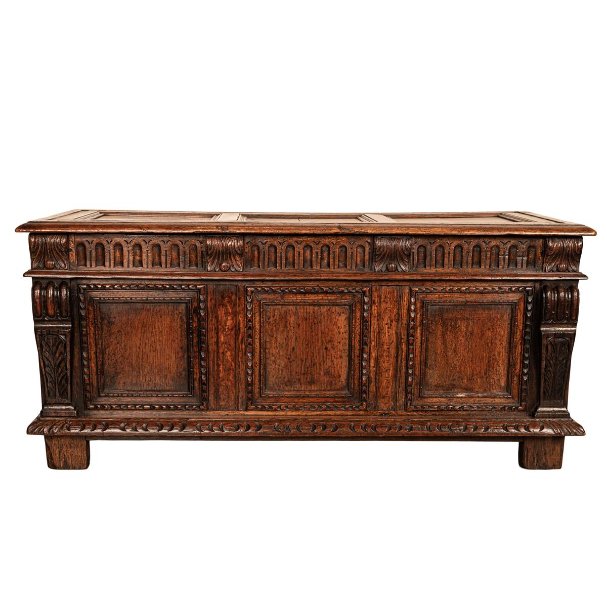 A good antique carved oak Renaissance Revival oak coffer, chest, window seat, circa 1880.
The three paneled lid having hand-forged iron strap hinges, enclosing a storage reservoir below. The front of the coffer having a carved arcaded frieze which