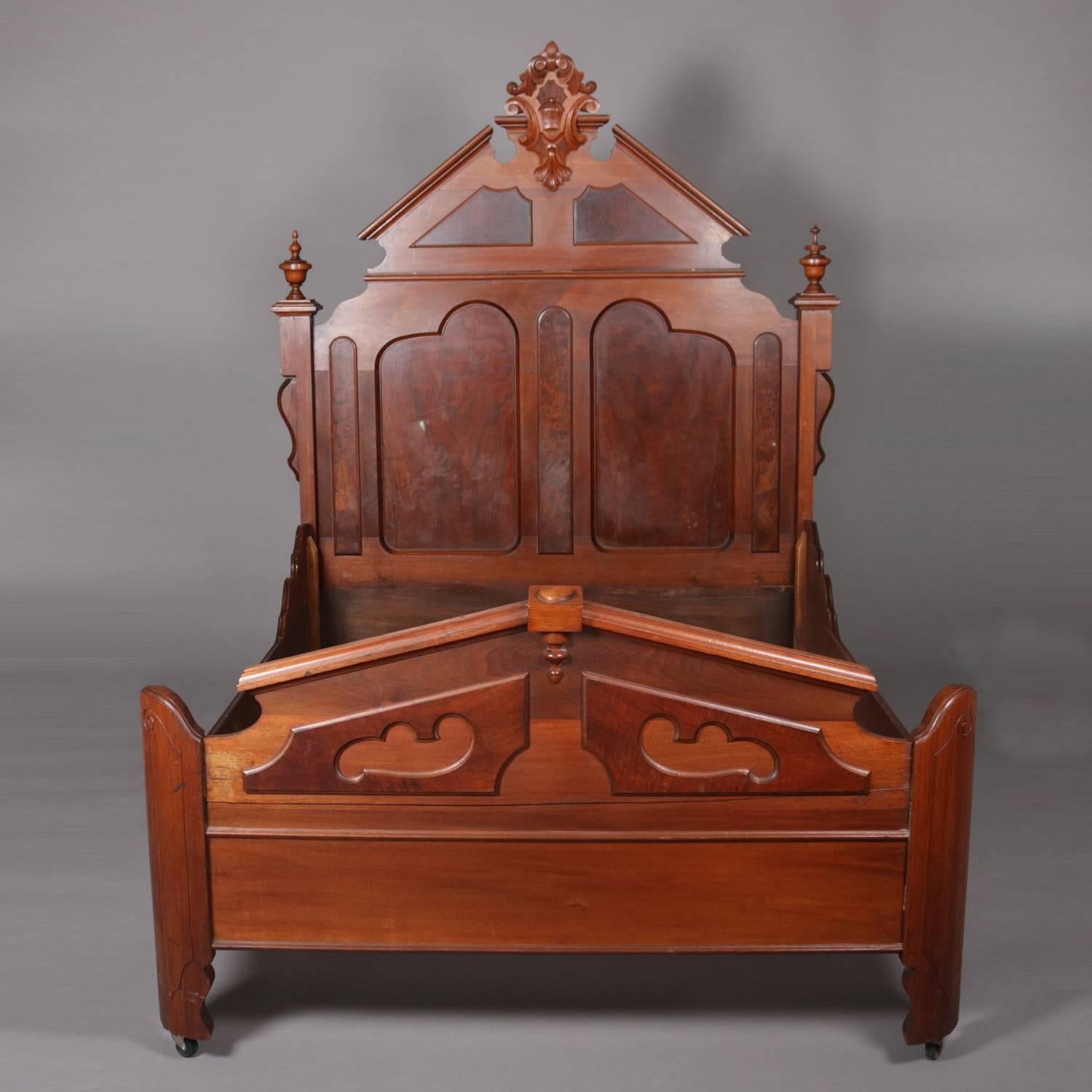 Antique Renaissance Revival carved walnut bed frame features broken arch crest with central scroll and foliate cartouche, headboard with burl panels and flanked by columns with turned finials, full/double size, circa 1890.

Measures: fr 77.5