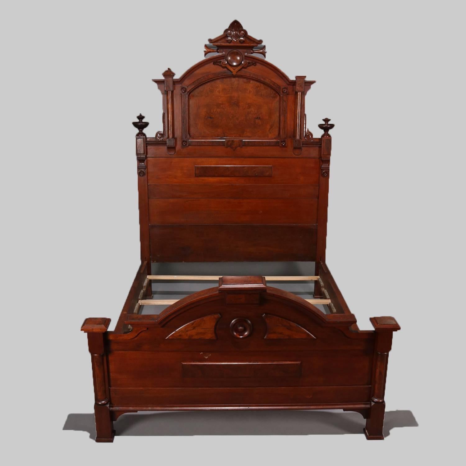 Antique Renaissance Revival carved walnut bed frame features carved fleur de lis crest, arch form headboard with burl panels and flanked by columns with turned finials, full/double size, circa 1870.

Measures: 89