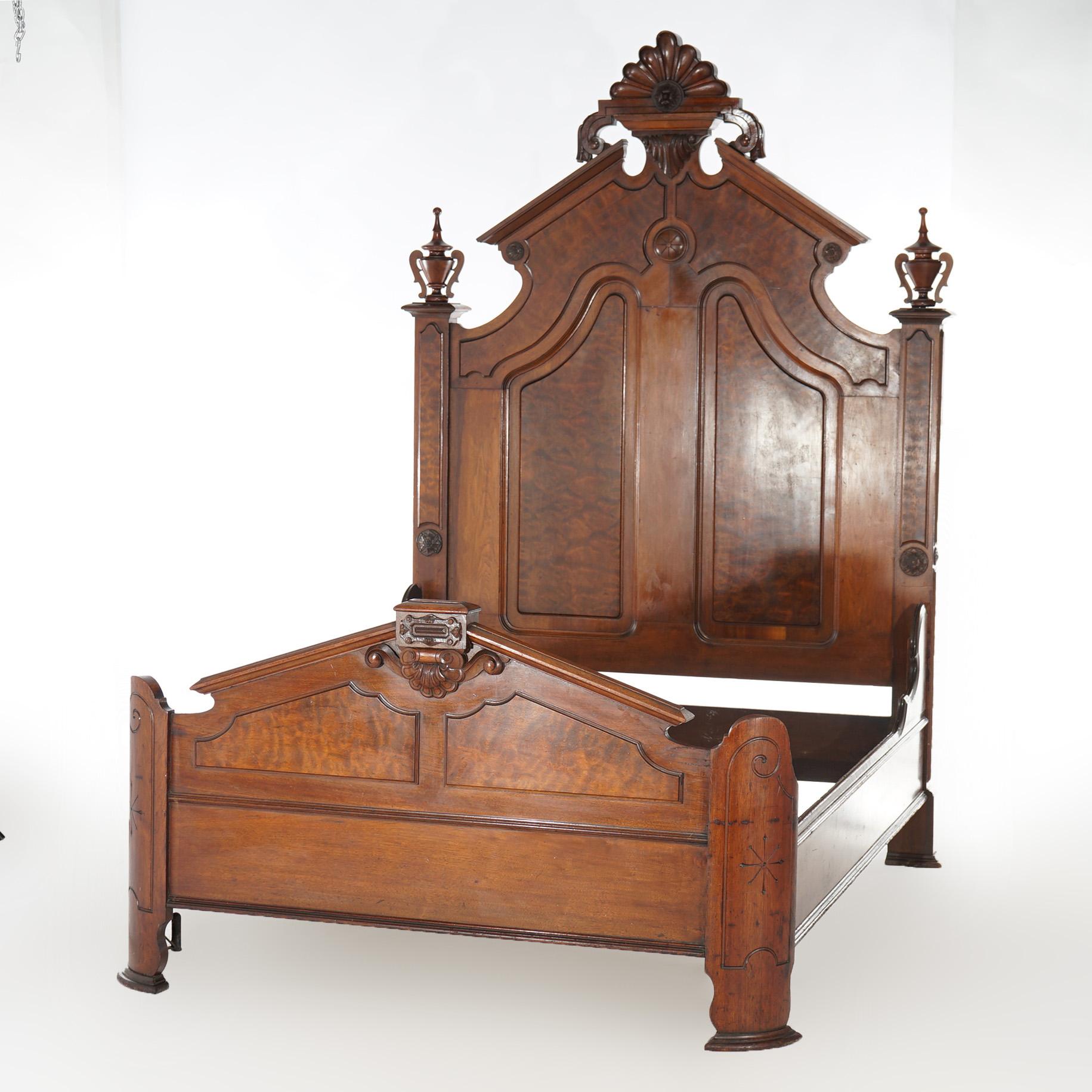 An antique Renaissance Revival full size bed frame offers walnut construction with burl panels, carved stylized palmette crest, flanking urn form finials, and 
 matching footboard, 19th century

Measures- Overall: 82''L x 61''W x 79.75''D; interior