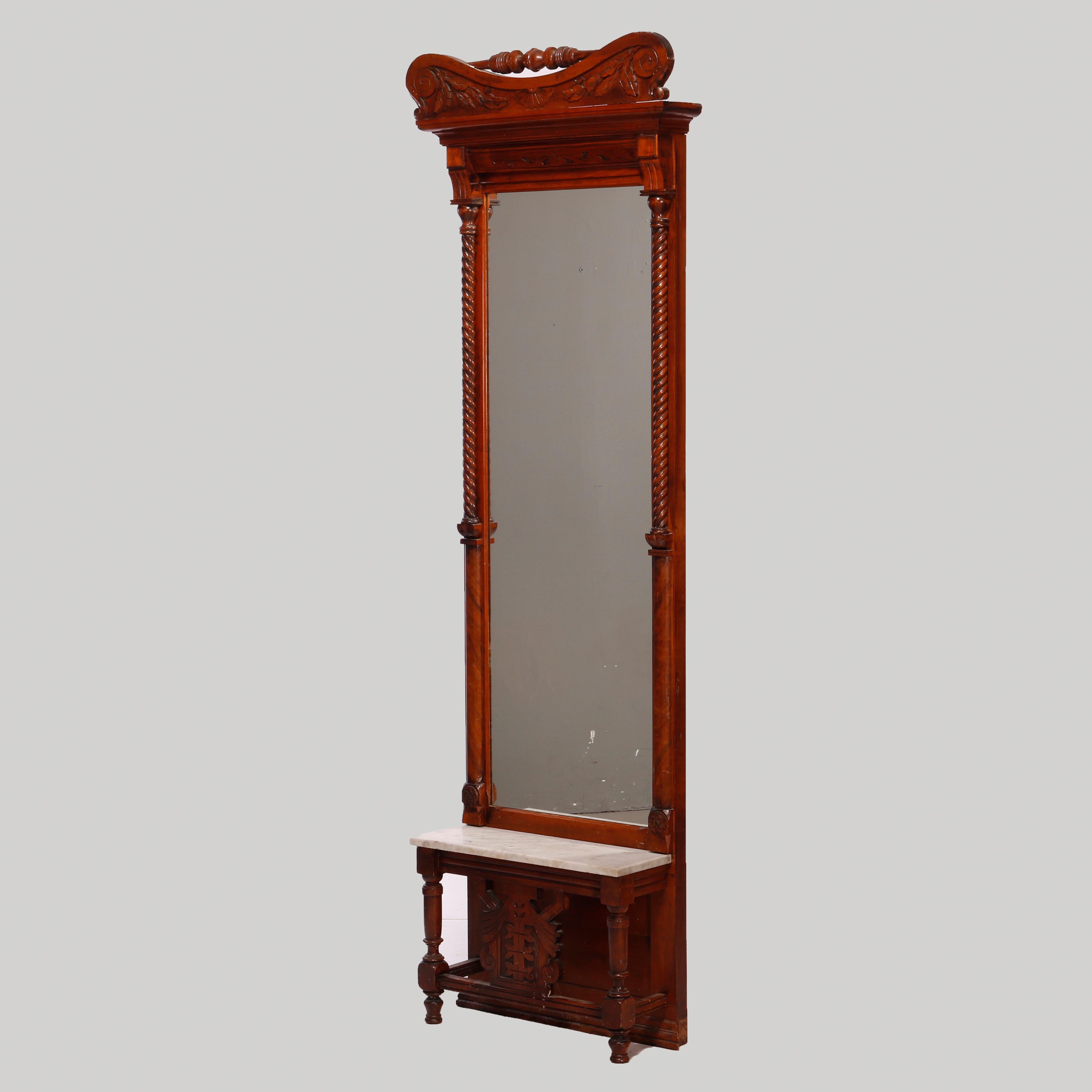 An antique Renaissance Revival pier mirror offers walnut and burl construction with foliate carved crest and turned column stretcher over full length mirror seated on marble top base with incised decoration, c1880

Measures - 92.5''H X 26.75''W X