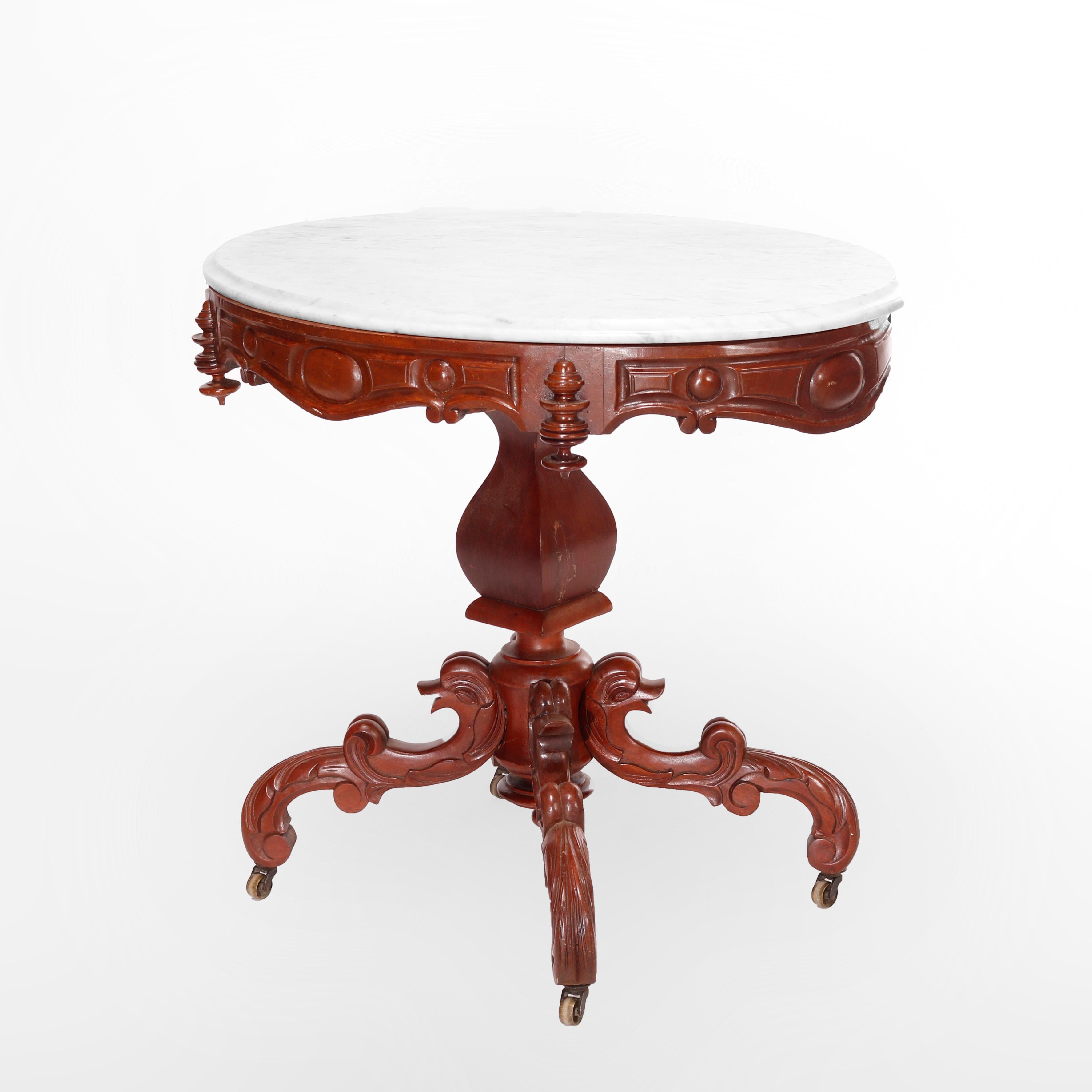 A Renaissance Revival center table offers oval beveled marble top over carved walnut base having shaped skirt and raised on center column having central urn form element raised on stylized scrolled gooseneck form legs, c1880

Measures - 29.5'' H x