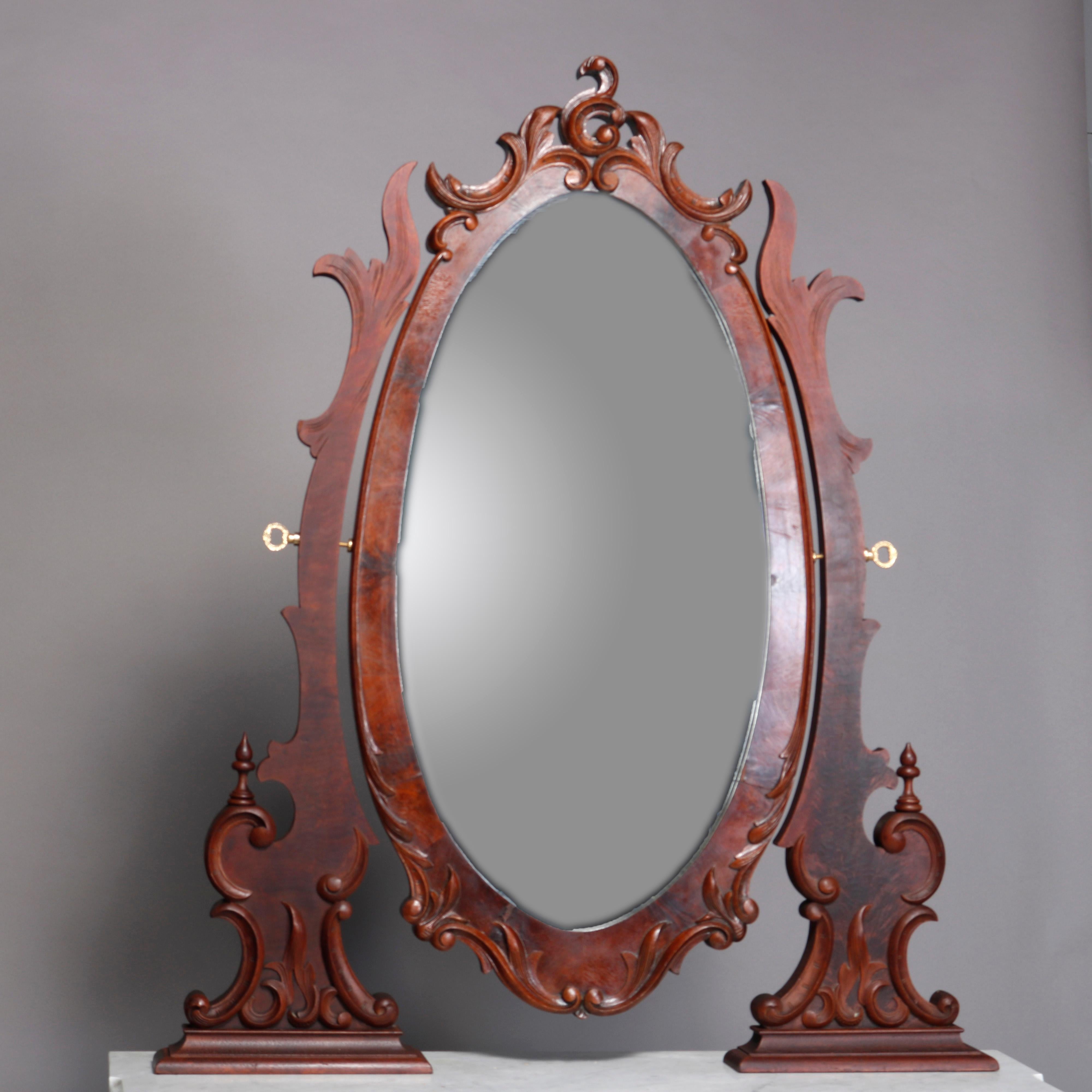 Antique mahogany Renaissance Revival dresser offers large oval dressing mirror with scroll and foliate frame surmounting chest having shaped and beveled marble top and case with three graduated drawers having bookmatched panels with scroll form