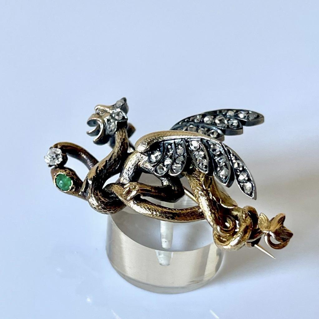 Superb dragon and snake 18K gold brooch in the Renaissance Revival style from the end of the 19th Century. A particularly grotesque and fearsome mythical winged Dragon fighting with a snake. The symbolism of this brooch is as a talismanic protector