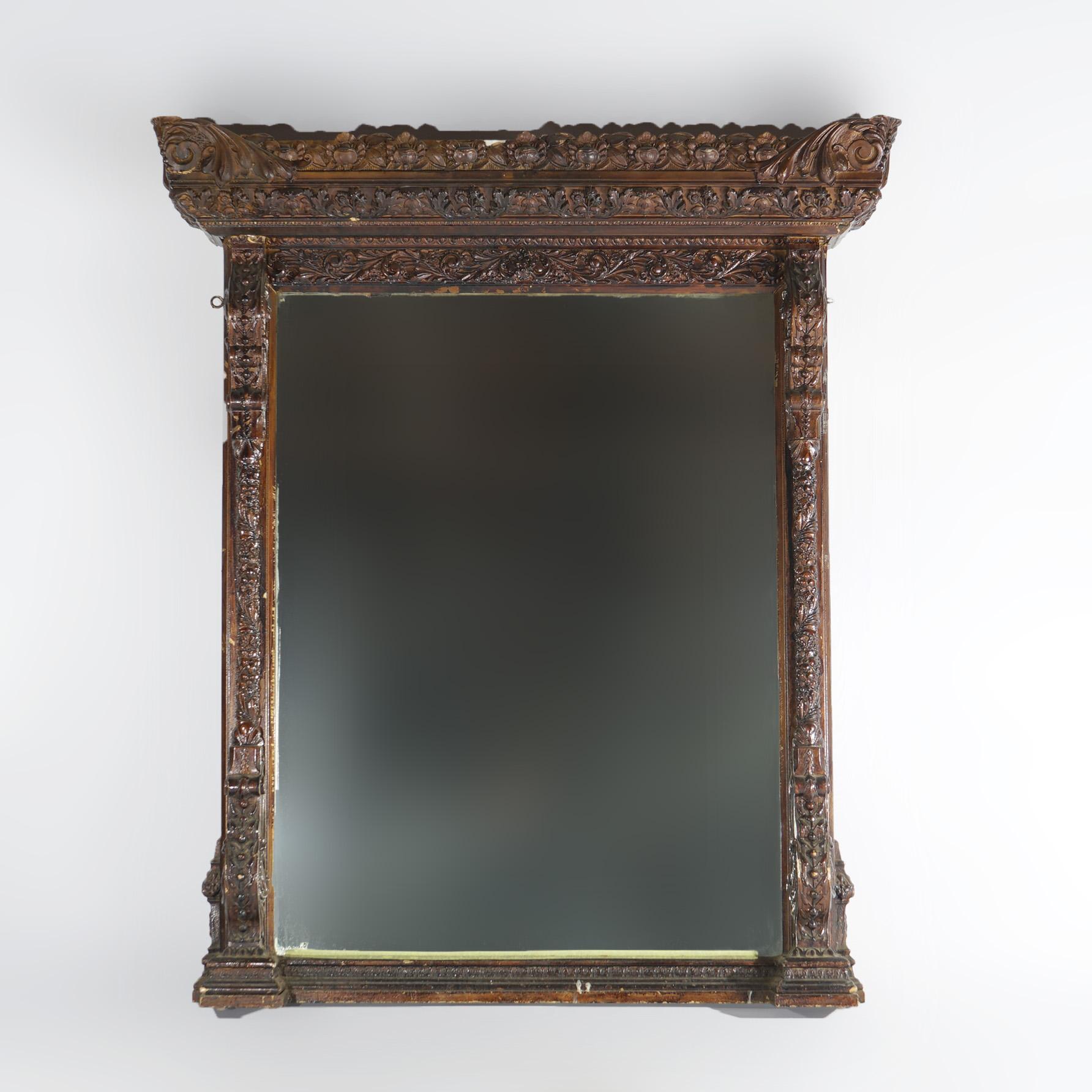 Miroir de cheminée antique de style Renaissance, avec cadre en bois sculpté et gesso présentant des éléments de feuillage, de fruits, de noix et de volutes, 19e siècle.

Dimensions - 60 