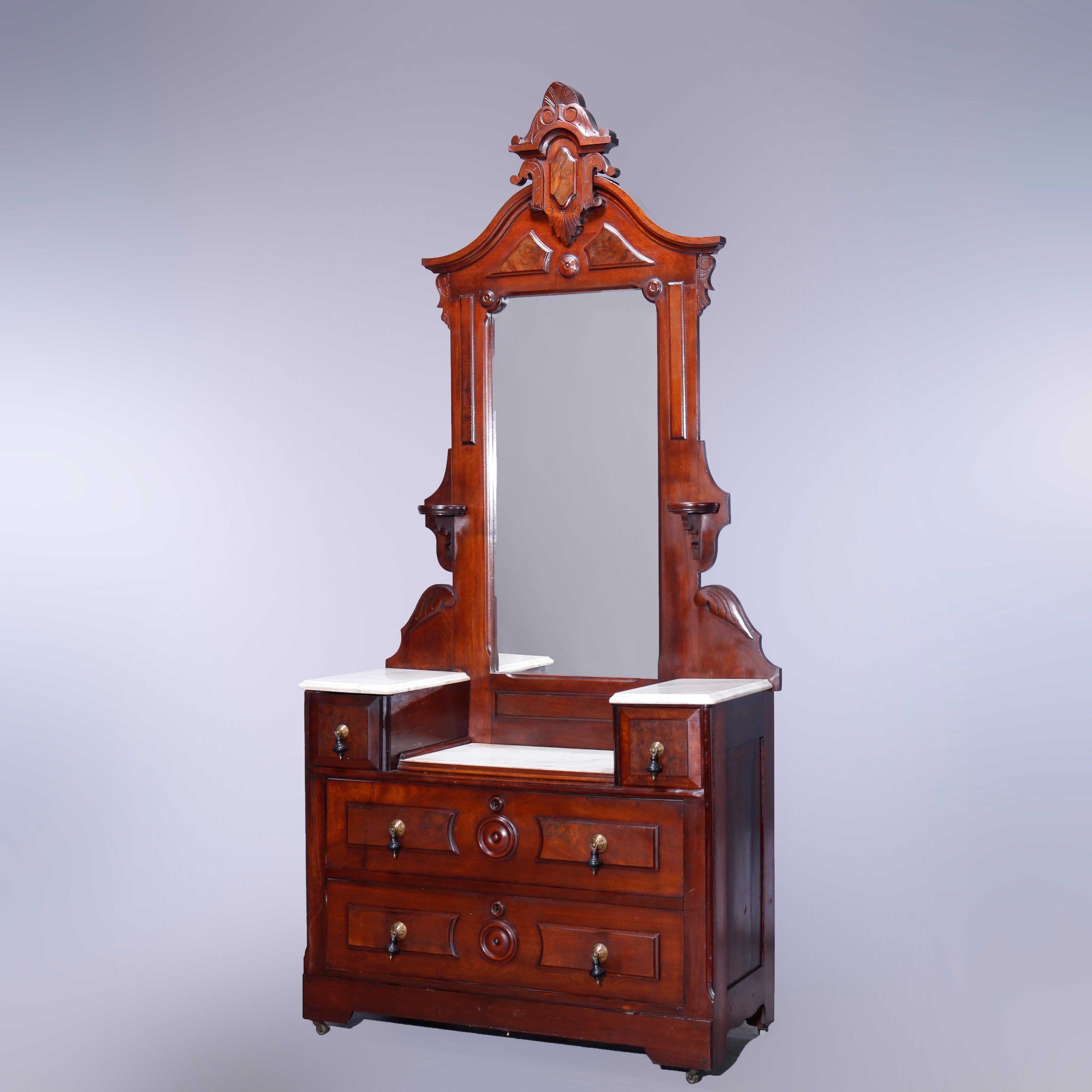 An antique Renaissance Revival dresser offers walnut construction with mirror having carved shield cartouche over frame with flanking candle stands and surmounting chest with marble top and flanking glove boxes over chest with two burl-paneled long
