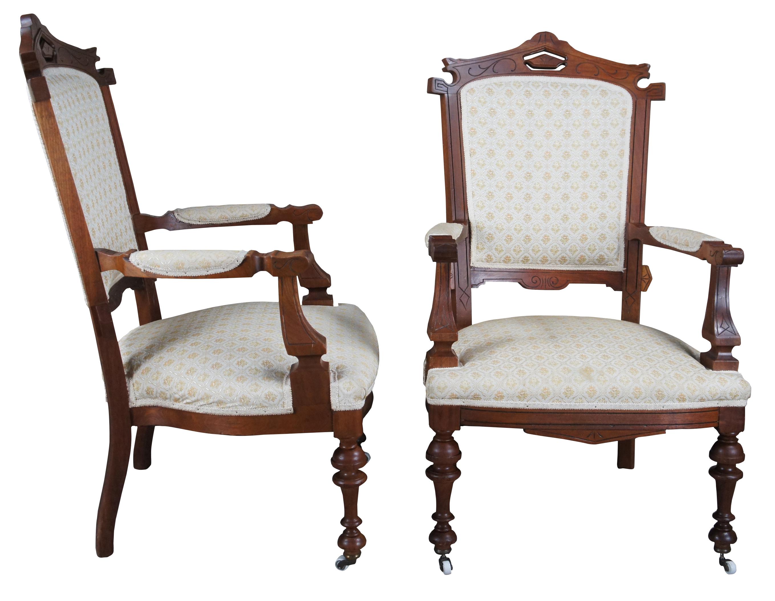 Antique Victorian Renaissance Revival gentleman's library or parlor armchairs.  Made of carved walnut featuring ornate Eastlake design with pierced crown, fauteuil arms and turned legs with castors.

25
