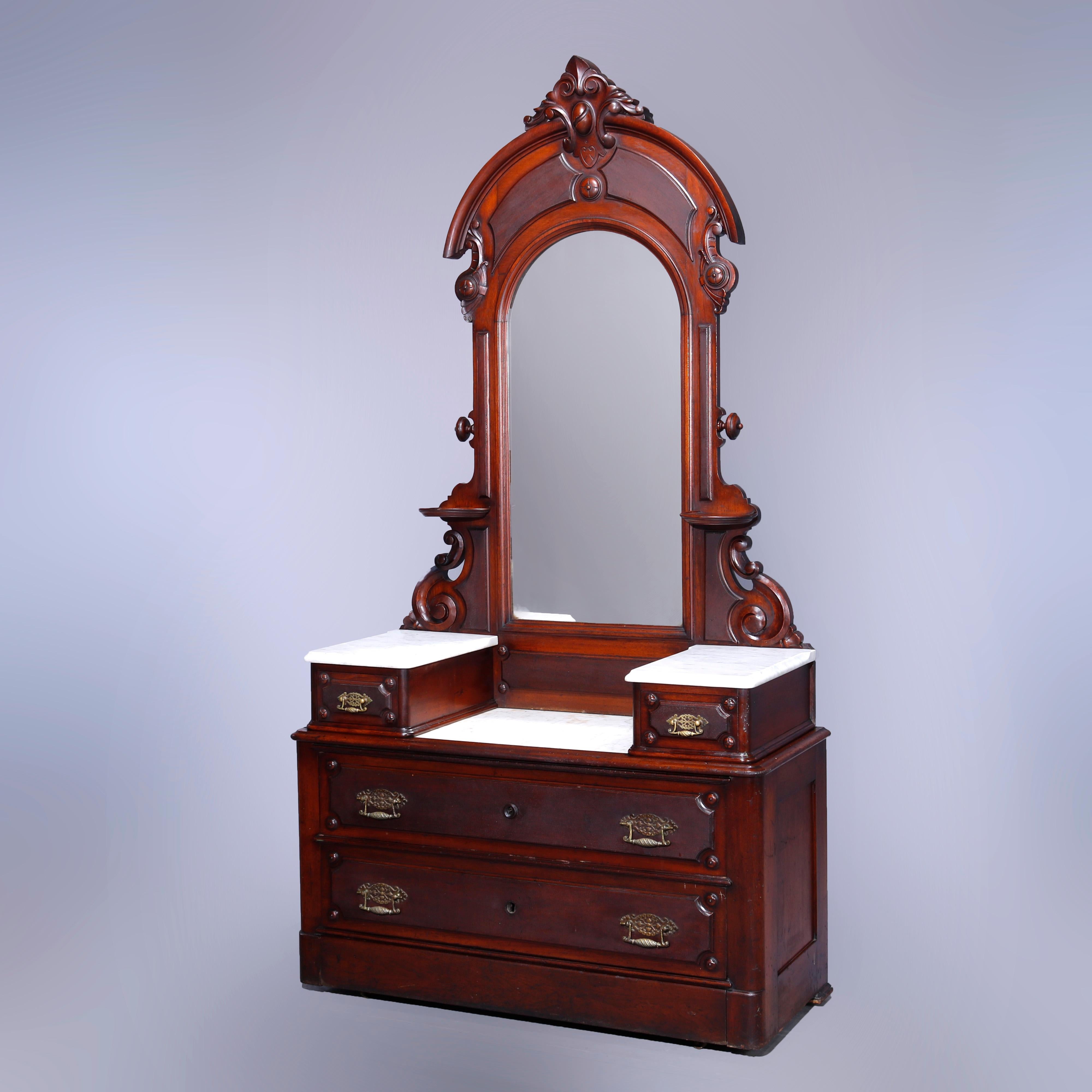 An antique Renaissance Revival dresser offers walnut construction with dressing mirror having carved foliate cartouche over frame with candle stands and flanking scroll corbels surmounting drop-center case having marble top, flanking glove boxes and