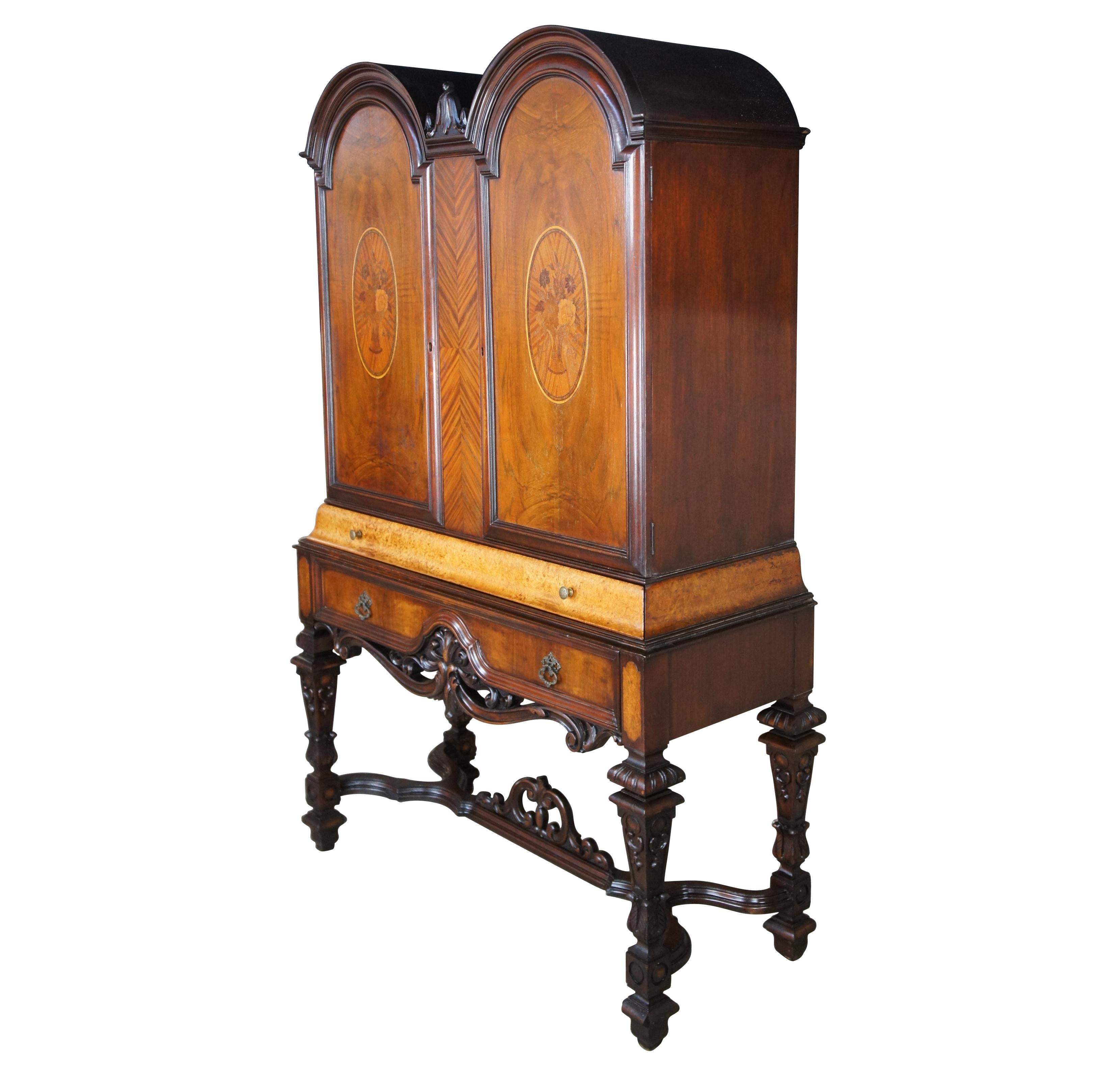 A beautiful early 20th century Renaissance Revival china hutch or bookcase. Made from walnut with exotic floral marquetry inlays, matchbook veneer and eye catching burl. The cabinet features an arched arcade form over a cornice drawer and larger