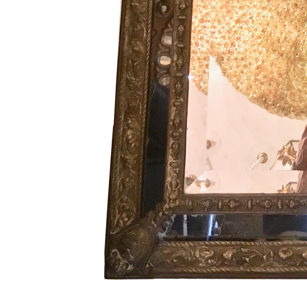 A late 19th century Dutch repousse' mirror with foliage motif and crowned by a lion.

Measurements:
Height: 42