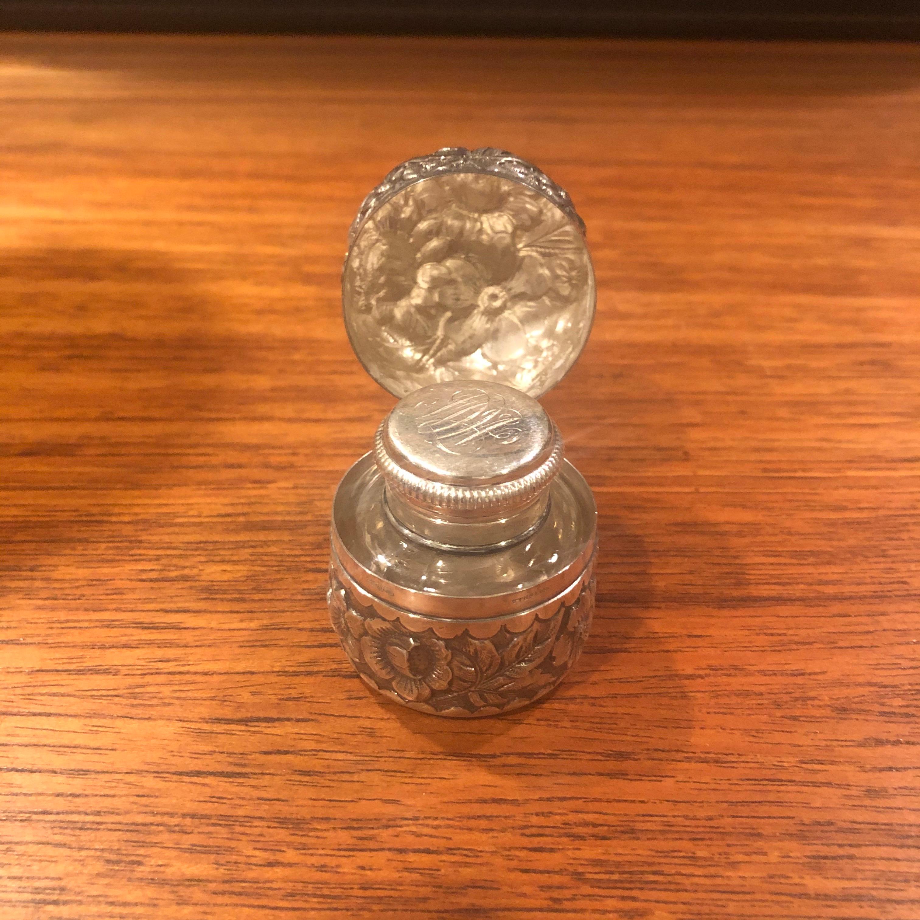 Antique hand-hammered repousse sterling silver inkwell, circa 1900. The inkwell has a single back hinge to open the lid and a screw cap and the glass liner. Fine condition and rich patina.



  