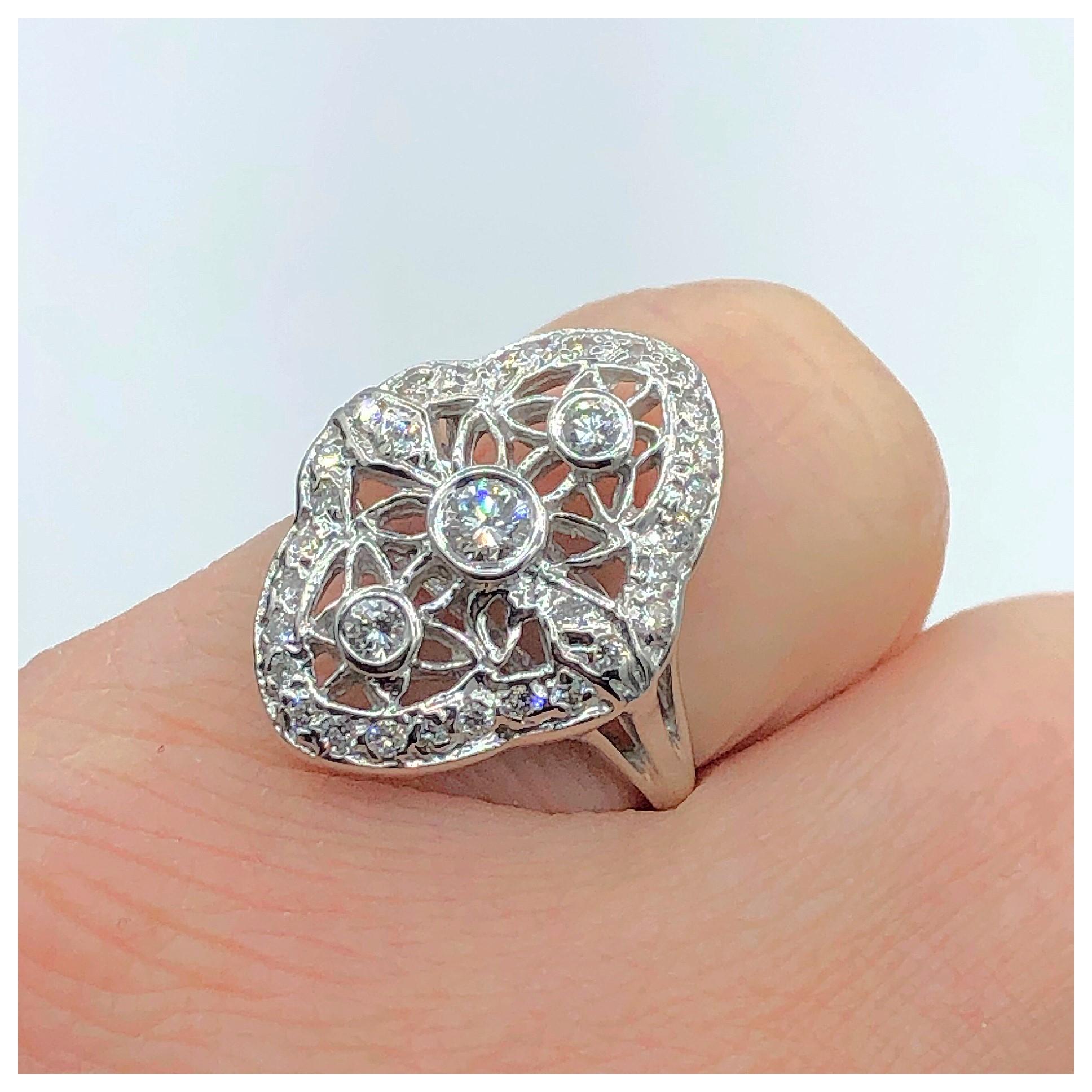 This beautiful antique reproduction in 14 Karat white gold contains .51 ct. of G color SI1 clarity diamonds. It measures approximately 20 x 16 millimeters. It is a finger size 6.5 but can easily be made to fit!
If you don't see something, say
