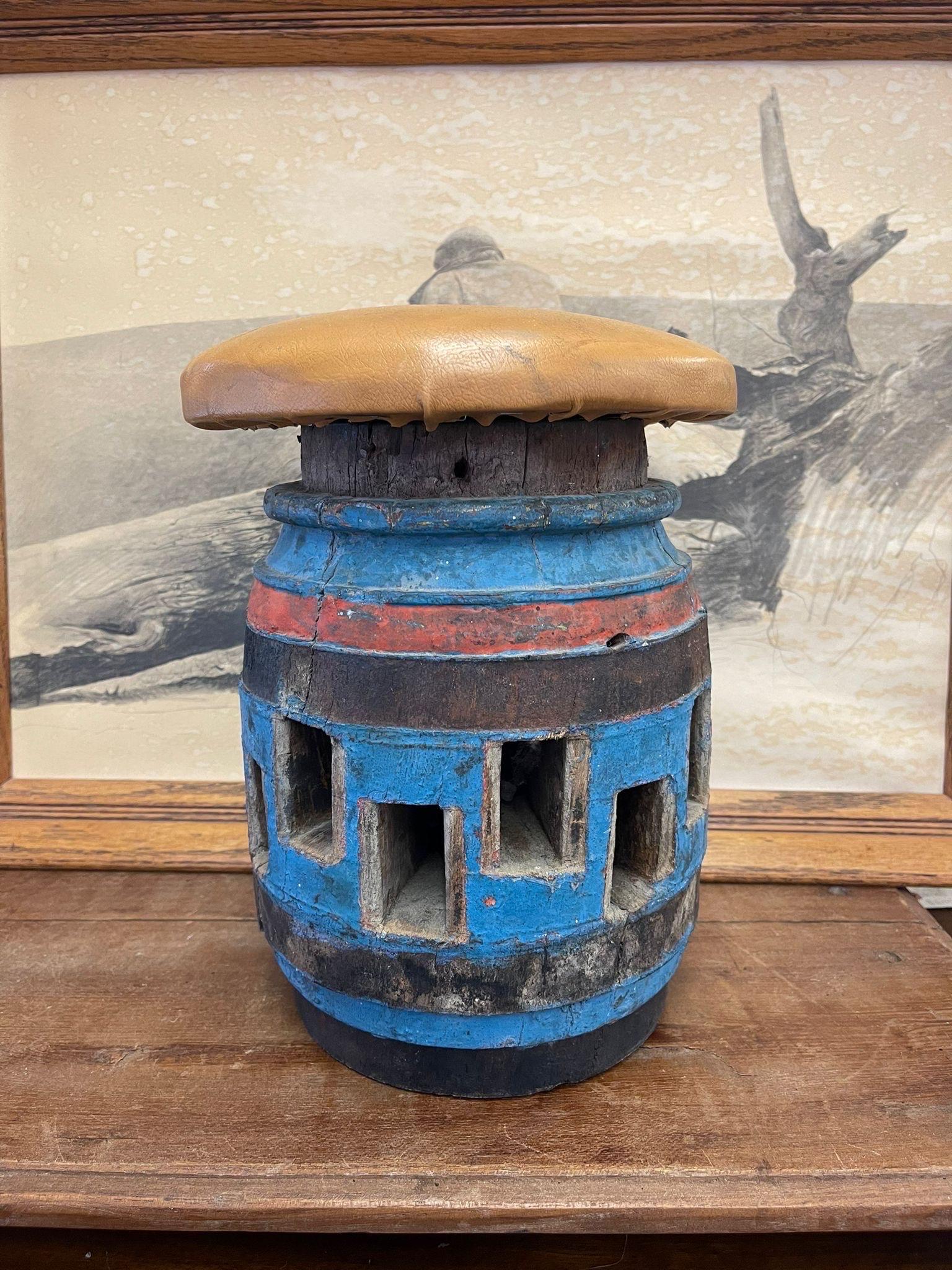 Rustic Art piece with tan seat, could be used as a small stool or footrest. Rad, blue and black colored Accents. Vintage Condition Consistent with Age as Pictured.

Dimensions. 9 Diameter; 13 H