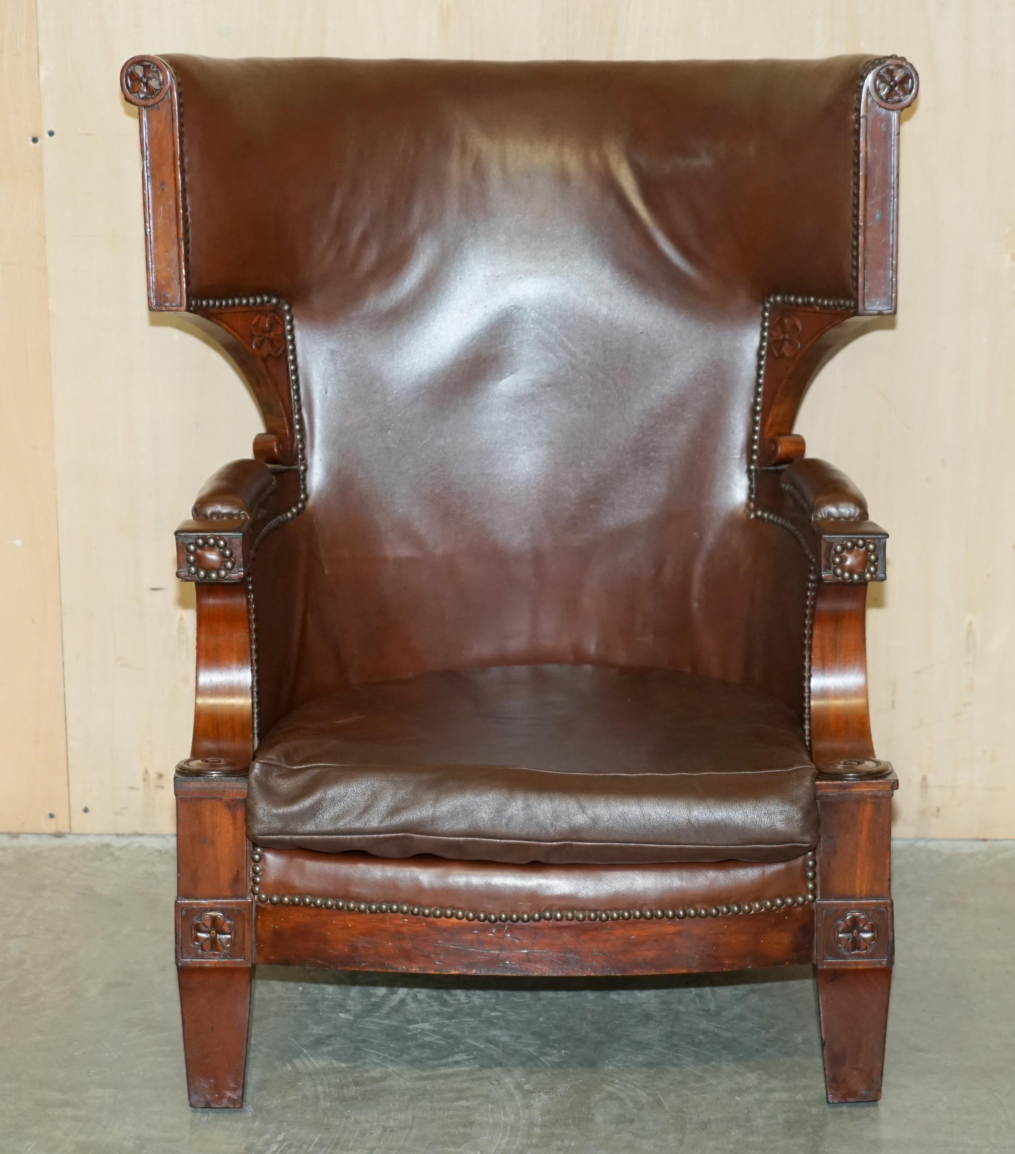 We are delighted to offer for sale this very uniquely shaped, Circa 1830 William IV, brown leather and Mahogany Wingback armchair with ornately carved frame 

A simply glorious piece, the frame is not something I have seen before, its very unique