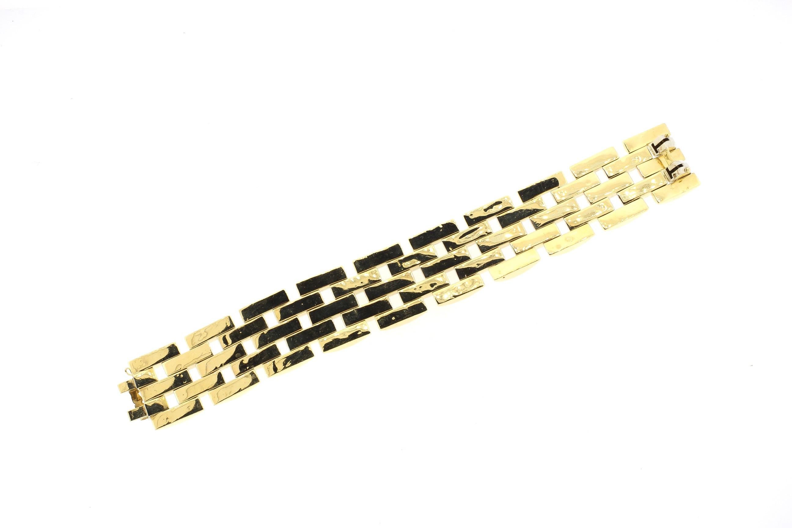 A Retro 18k tri color gold wide link bracelet, circa 1940. The three colors of gold - rose, yellow and green are classic Retro characteristics. This wide bracelet has alternating three rows and two rows of faceted links that create reflection. The
