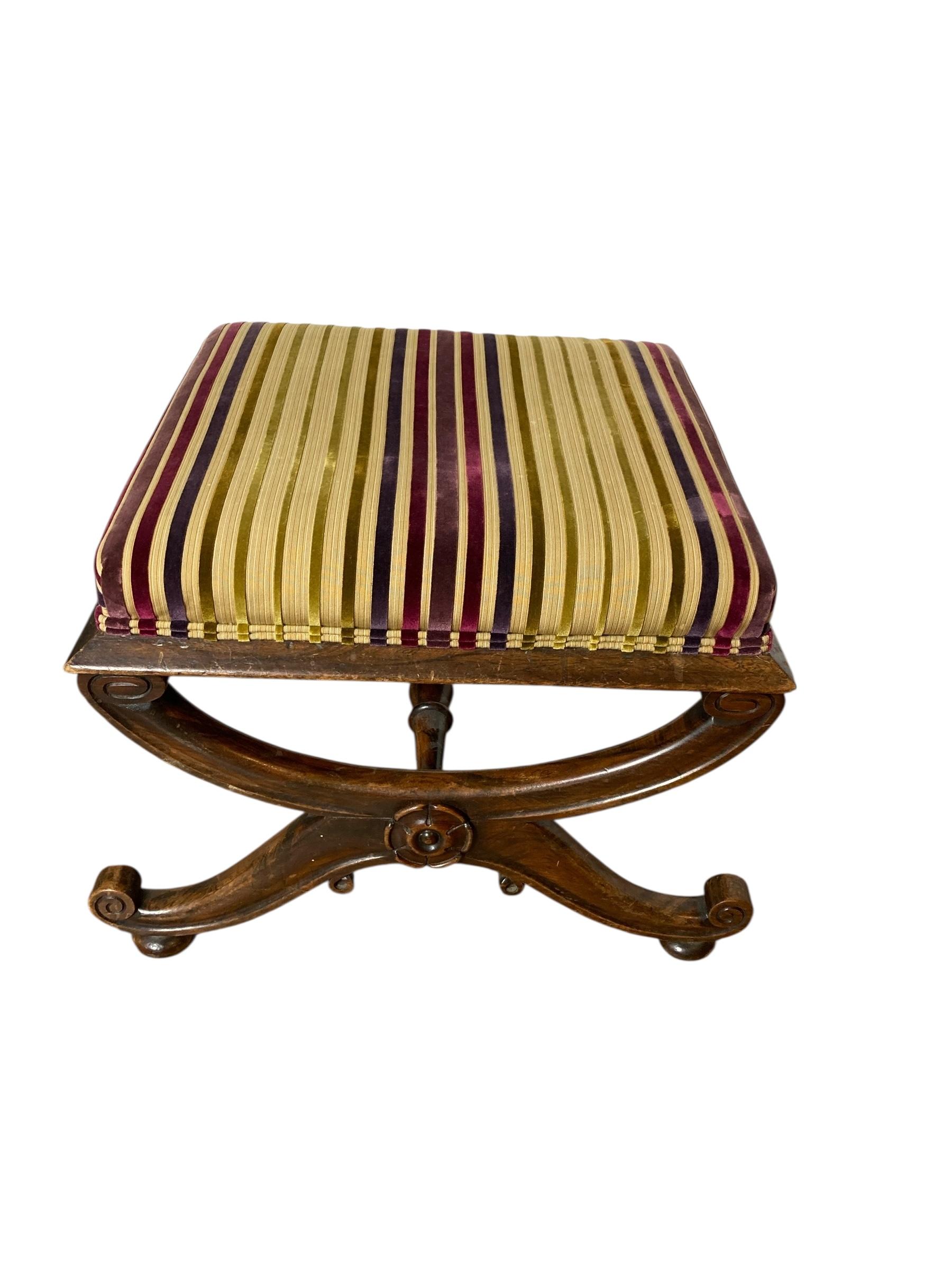 Antique Reupholstered Footsool Victorian Carved Legs. Stylish striped fabric top that adds a touch of sophistication. This versatile piece combines functionality with aesthetic appeal. Its compact size makes it an ideal addition to small spaces,