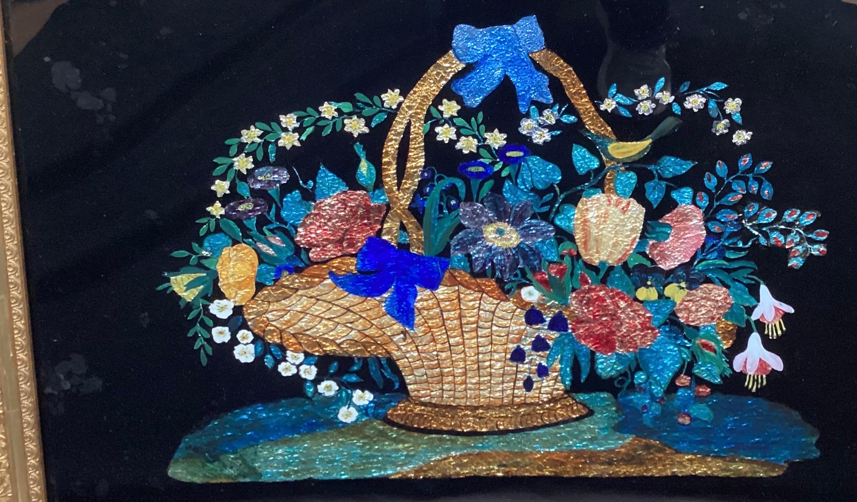 A charming reverse painting on glass of a floral filled basked.  The black background with vibrant color floral and foil behind glass, in original gilt frame.  