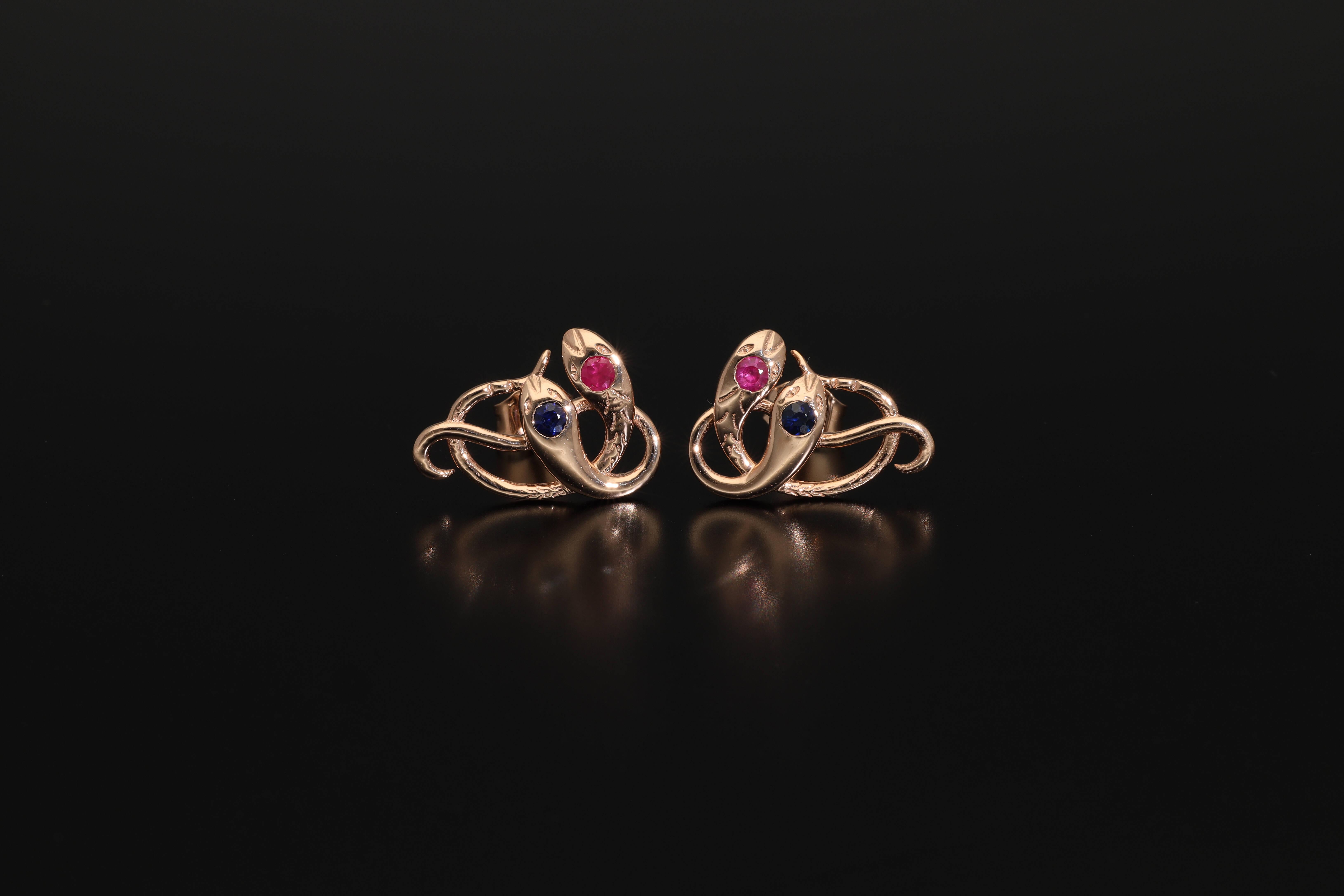 A  beautiful antique revival pair of rose gold snake stud earrings! These unique statement earrings are made of solid 14 karat gold and are set with natural rubies and sapphires.
Snake rings were extremely popular in Victorian/Edwardian jewellery as