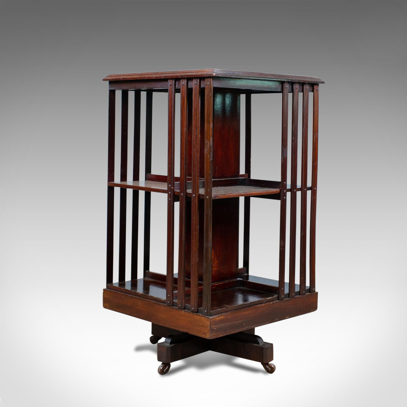This is an antique revolving bookcase. An English, Edwardian, walnut bookshelf dating to the early 20th century, circa 1910.

Walnut with satinwood crossbanding, evocative of the period
tabletop displaying good grain detail and a moulded edge