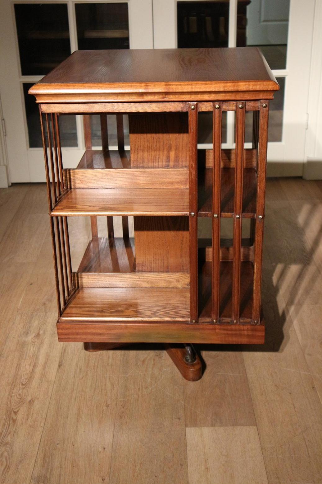 Beautiful antique revolving bookcase made of ash in combination with mahogany. This gives a nice contrast in colors.
revolving bookcase has a cast iron base which makes it very stabile. The revolving bookcase was made by the firm Maple & Co. This