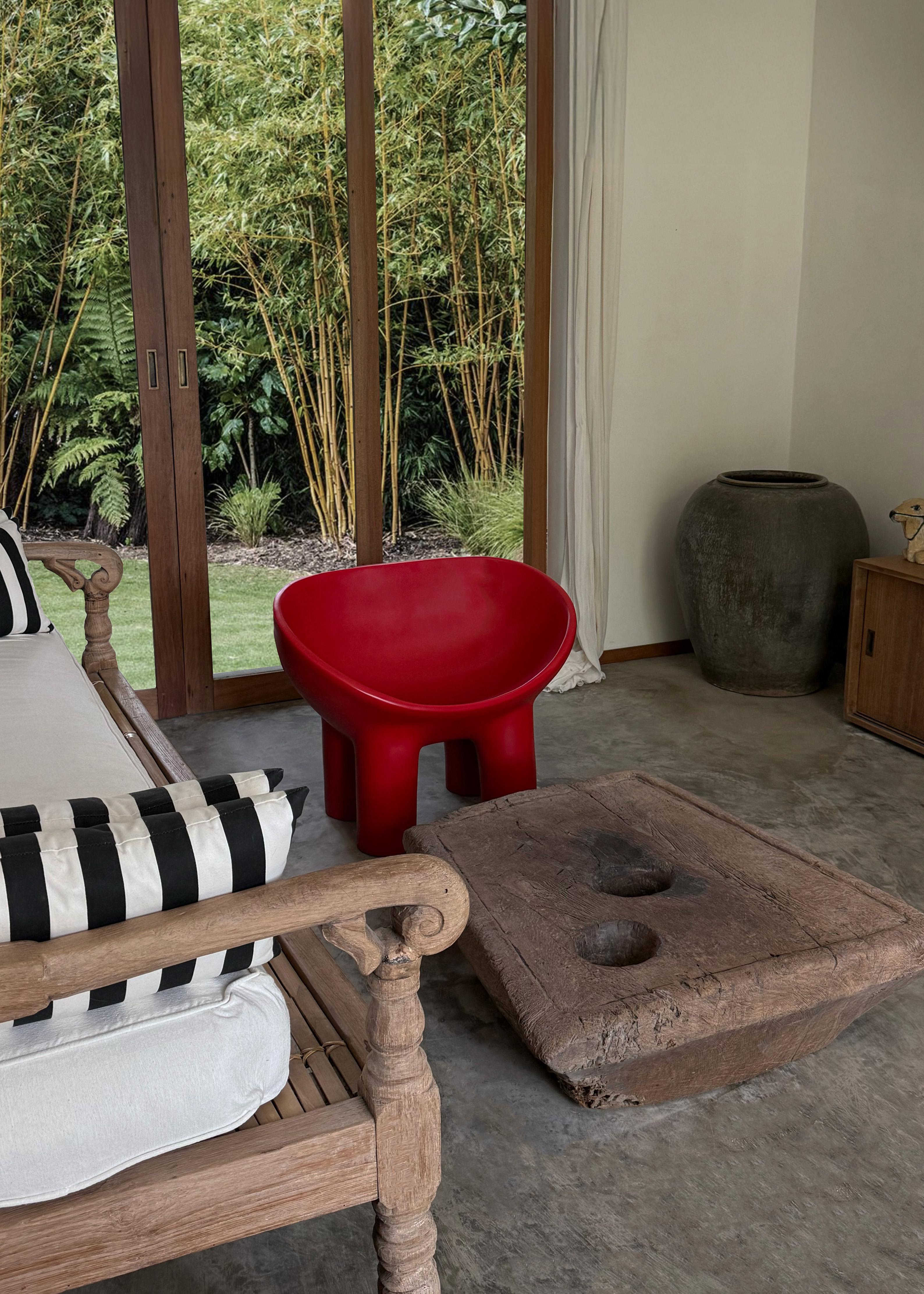 This striking piece is an antique rice mortar from Java, meticulously hand-carved from a single block of hardwood. Dating back over a century, it bears the rich marks of time—a weathered surface, deep grain, and an organic patina that can only be