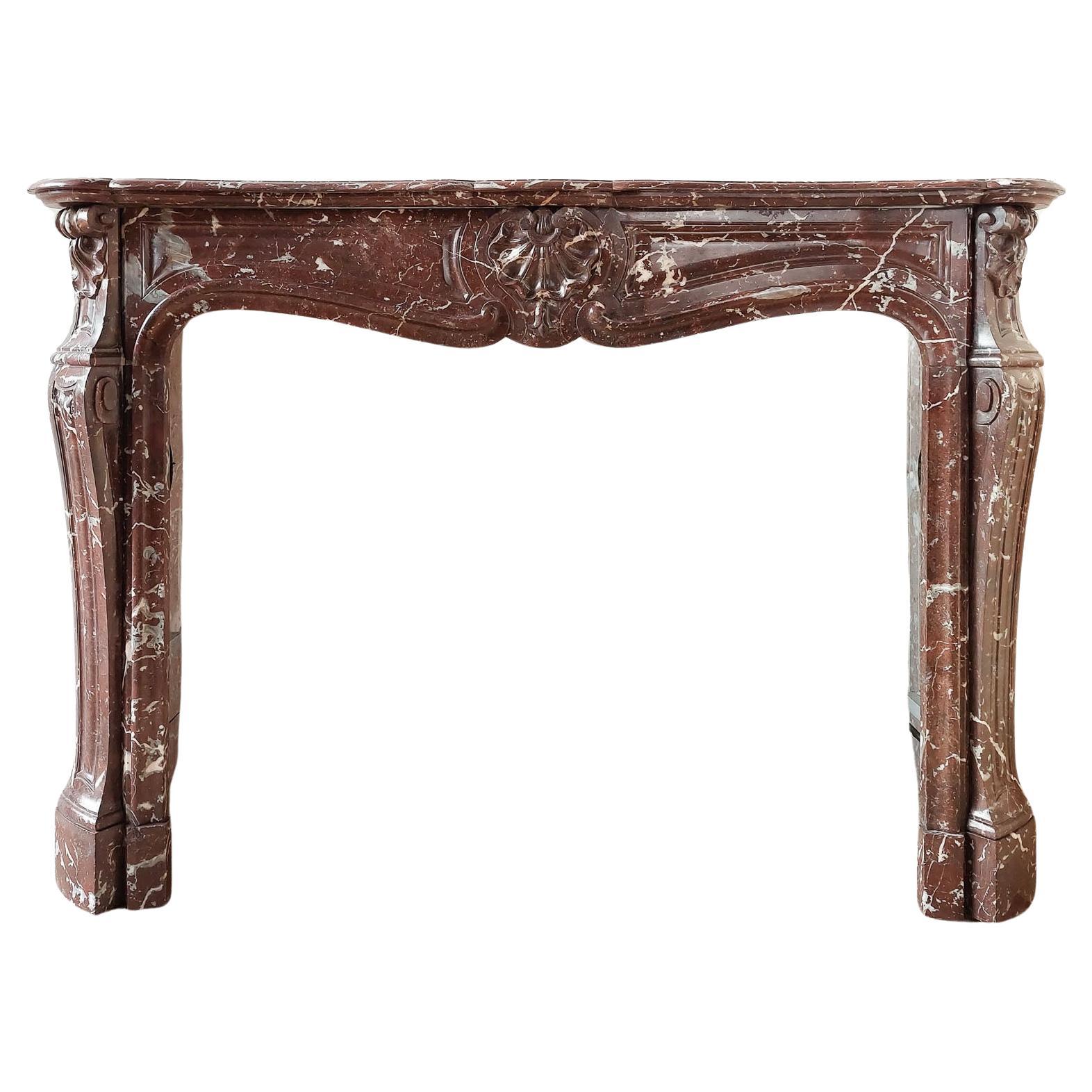 Antique, rich, hand-carved Trois Coquilles mantelpiece in red marble For Sale