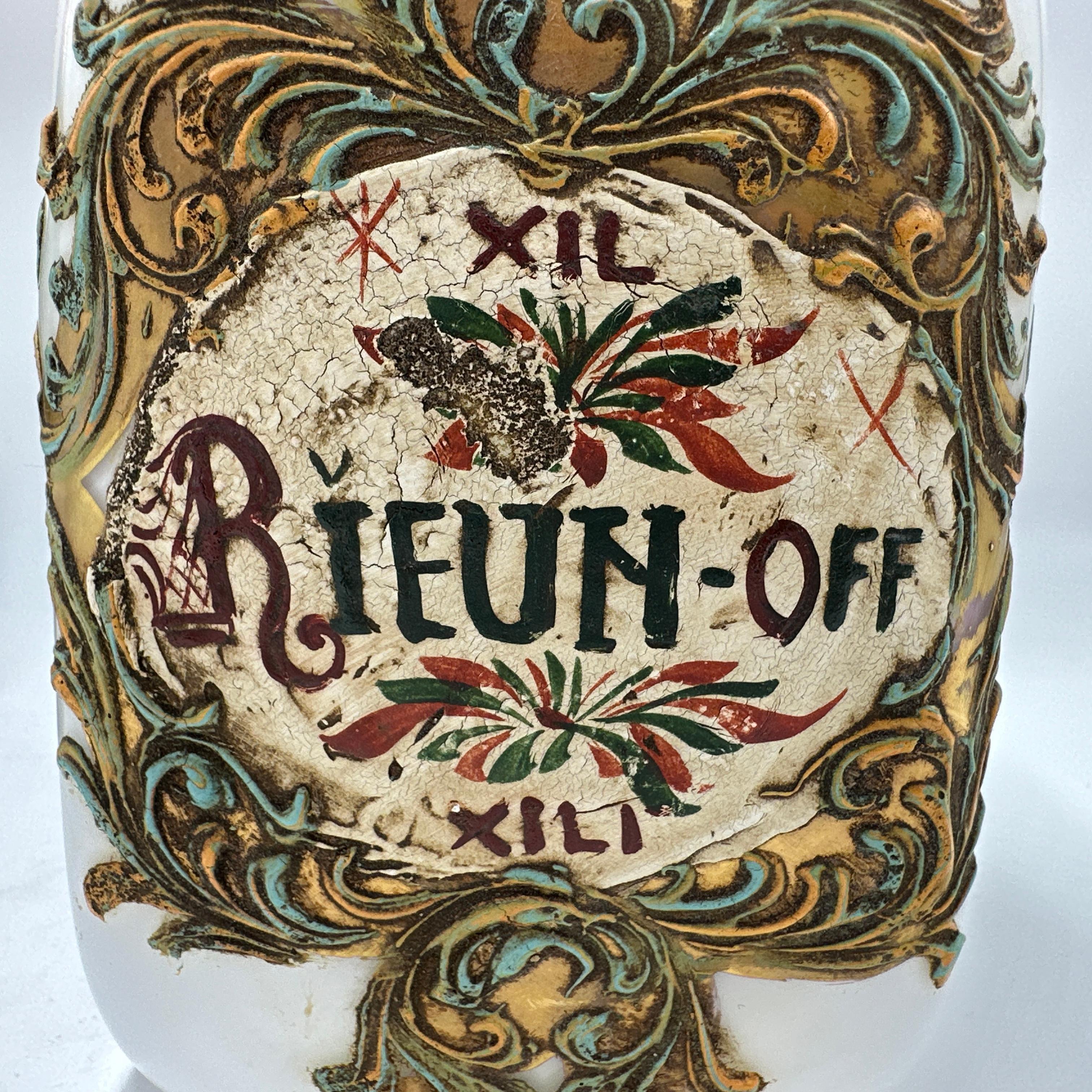 Here is a beautiful Antique Italian Murano Glass Pharmacy Apothecary Jar. Elaborately hand painted and gilt on white Murano glass. Featuring an strawberry with leaf on the lid. Reads “RIEUN” on the label. We could not find any specific information