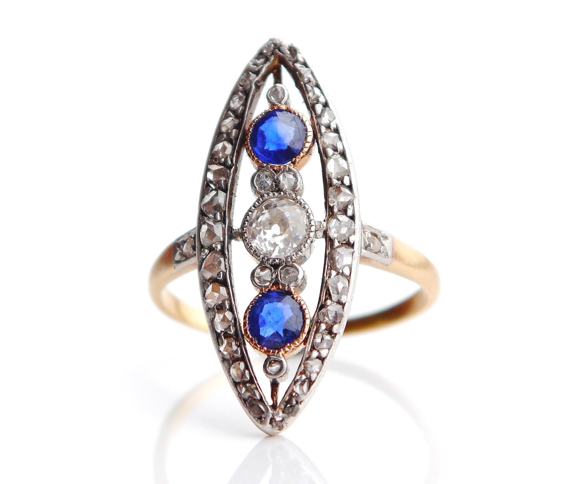 This old ring has navette or boat shaped crown with White Gold / or Platinum top on solid 18K Green Gold band set with natural Diamonds and Blue Sapphires. European made, dates to ca. early XX century.

Crown with stones measures 27 mm x 11 mm 3 mm