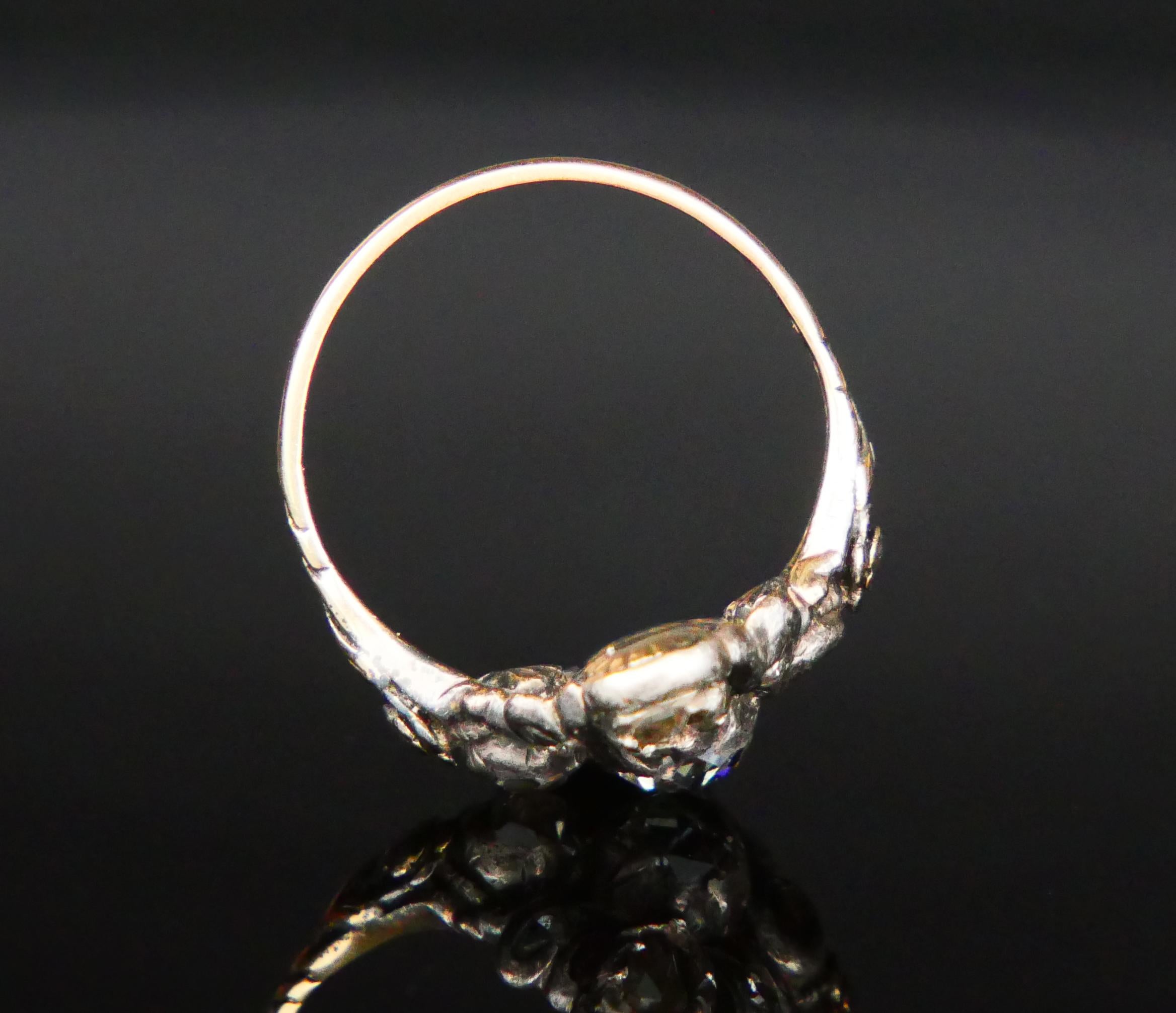 Old European Diamond cluster Ring with carved shoulders in solid 18ct Yellow Gold with Silver clusters on top of the crown holding nine rose-cut Diamonds that seem to have a reddish /rose tint.

All Diamonds have their backs closed and foiled