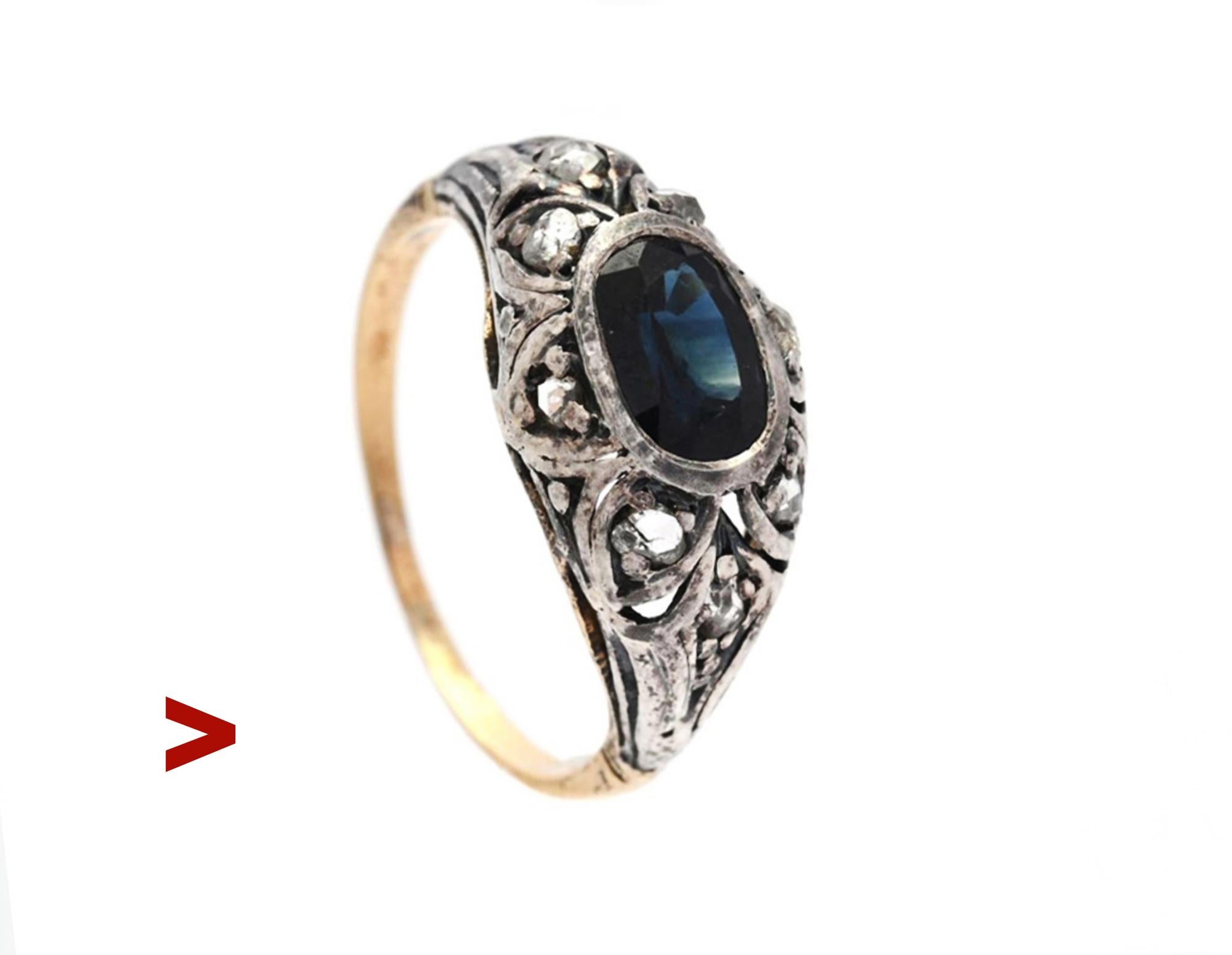 Late XIX - early XX century. European Ring with Silver on 18K Gold openwork crown with natural Blue Sapphire and 8 rose cut Diamonds.

Not hallmarked, band tested solid 18K .

Medium Blue natural Sapphire, old oval cut with inclusions and internal