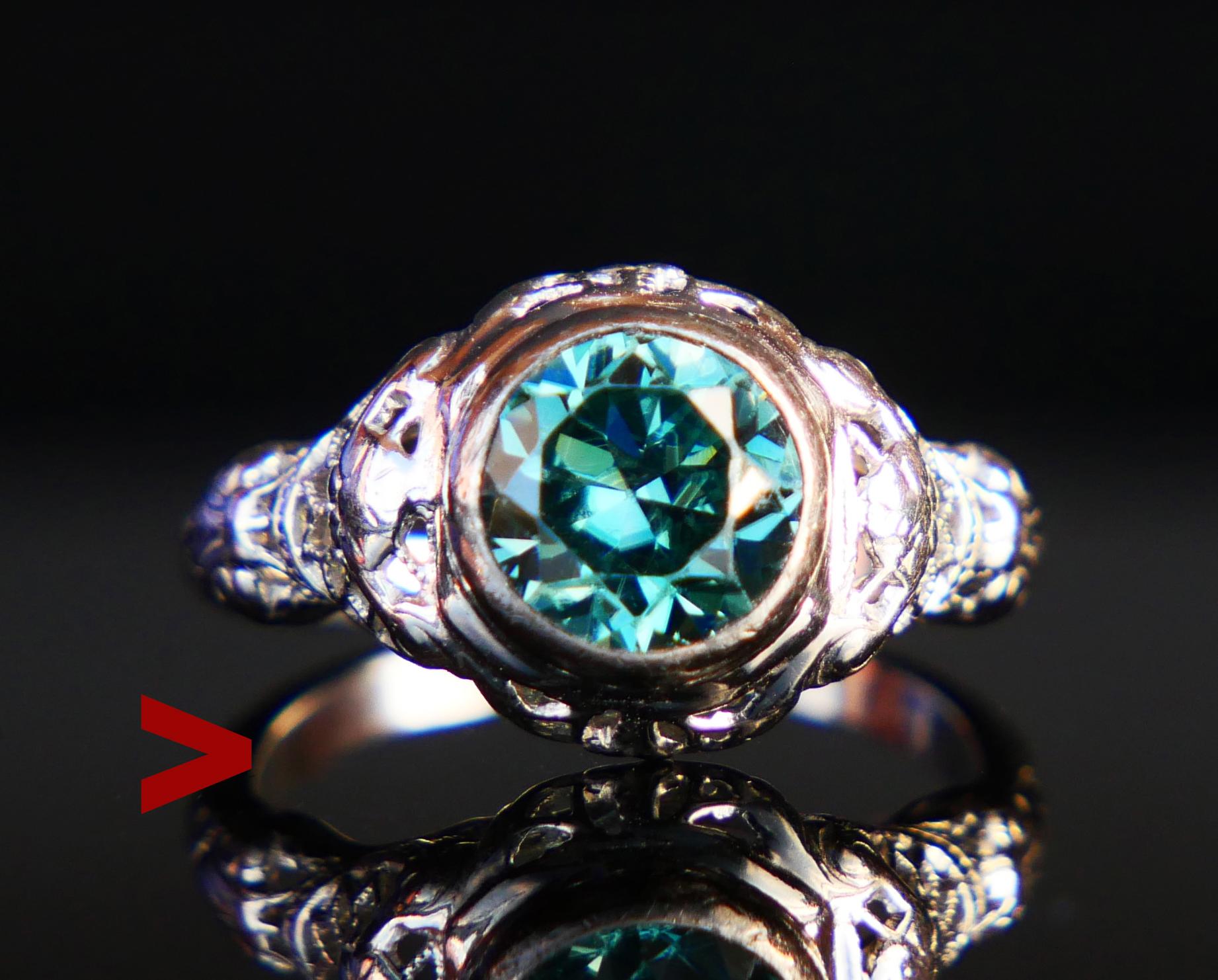 Ring featuring natural Zircon Ø 6.75 mm x 5 mm deep / ca. 1.75 ct / old European diamond cut , of vibrant Bluish Green color. Band with openwork shoulders in solid 18K White Gold . Stone's back is open.

Made in ca 1920s -1930s . Hallmarked 18K Gold