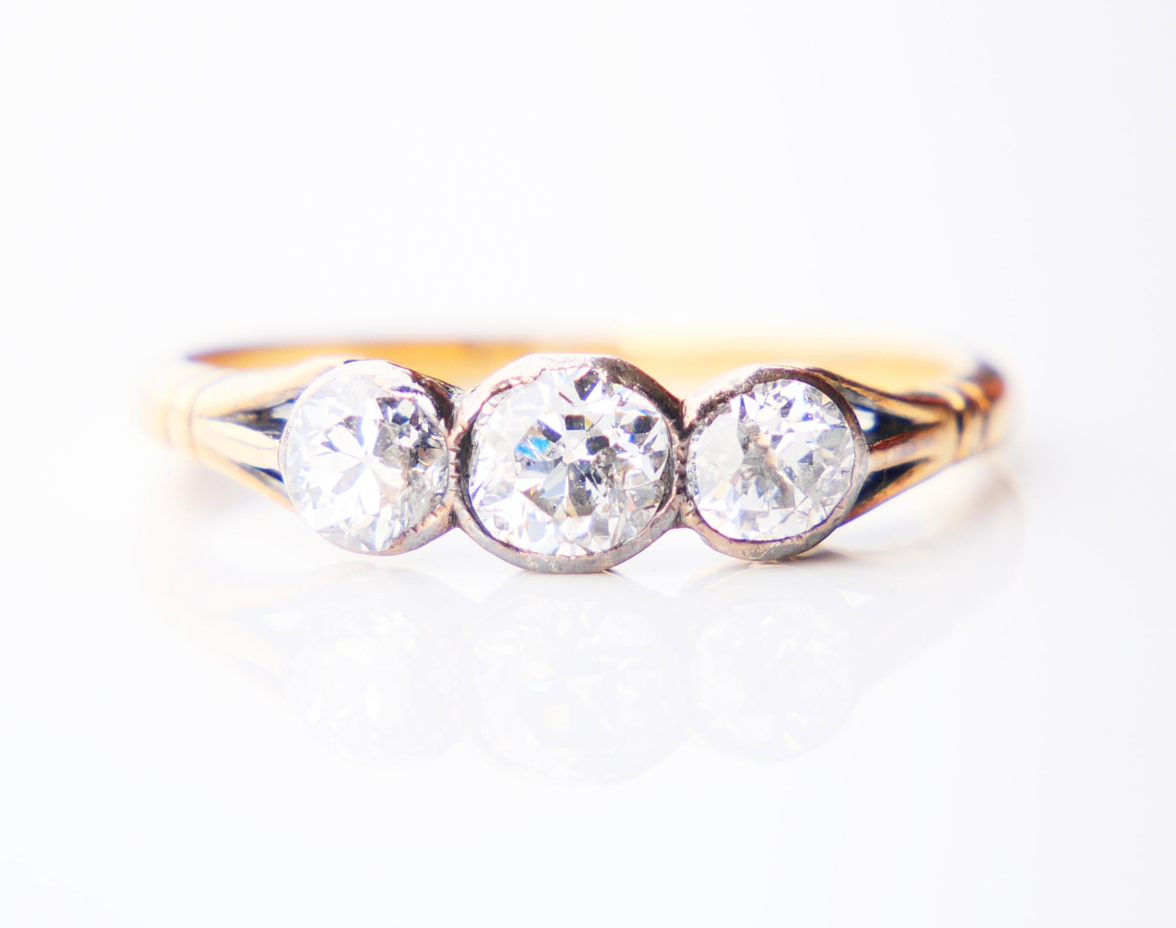 Old Ring with 3 old European cut Diamonds, band in solid 18K Yellow Gold (tested) with Silver clusters.

No hallmarks made ca. 1900s -1920s

Largest central oval cut Diamond 5 mm x 4 mm x 3 / 0.5 ct; two others Ø 4 mm x 2.8mm deep / 0.3 ct each.
