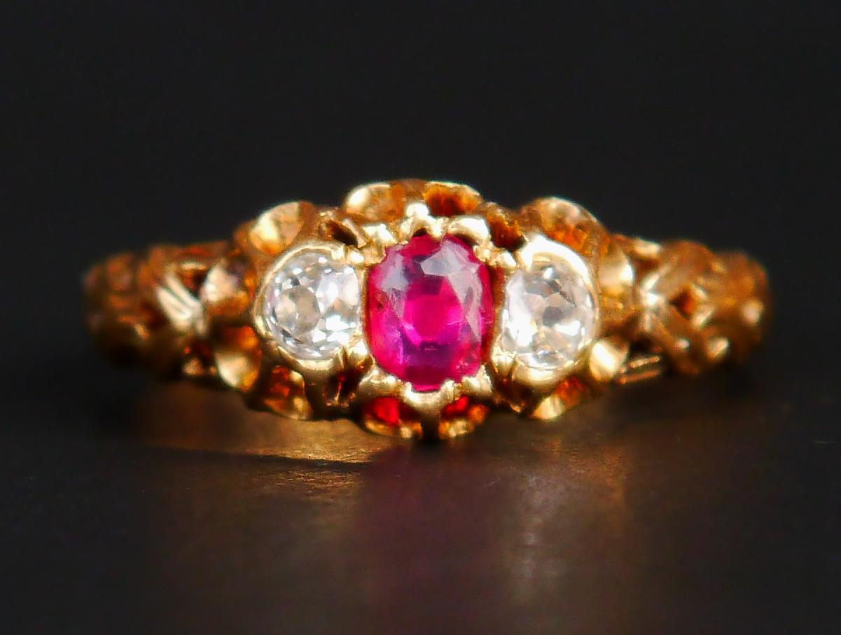 A Ring in solid 18K Yellow Gold band with braided shoulders holding old diamond cut natural Rose Red Ruby and 2 old diamond cut Diamonds. Not hallmarked ,metal tested solid 18K.

The crown with stones is 10 mm x 7 mm.  Ruby Ø 4 mm /ca 0.4 ct with