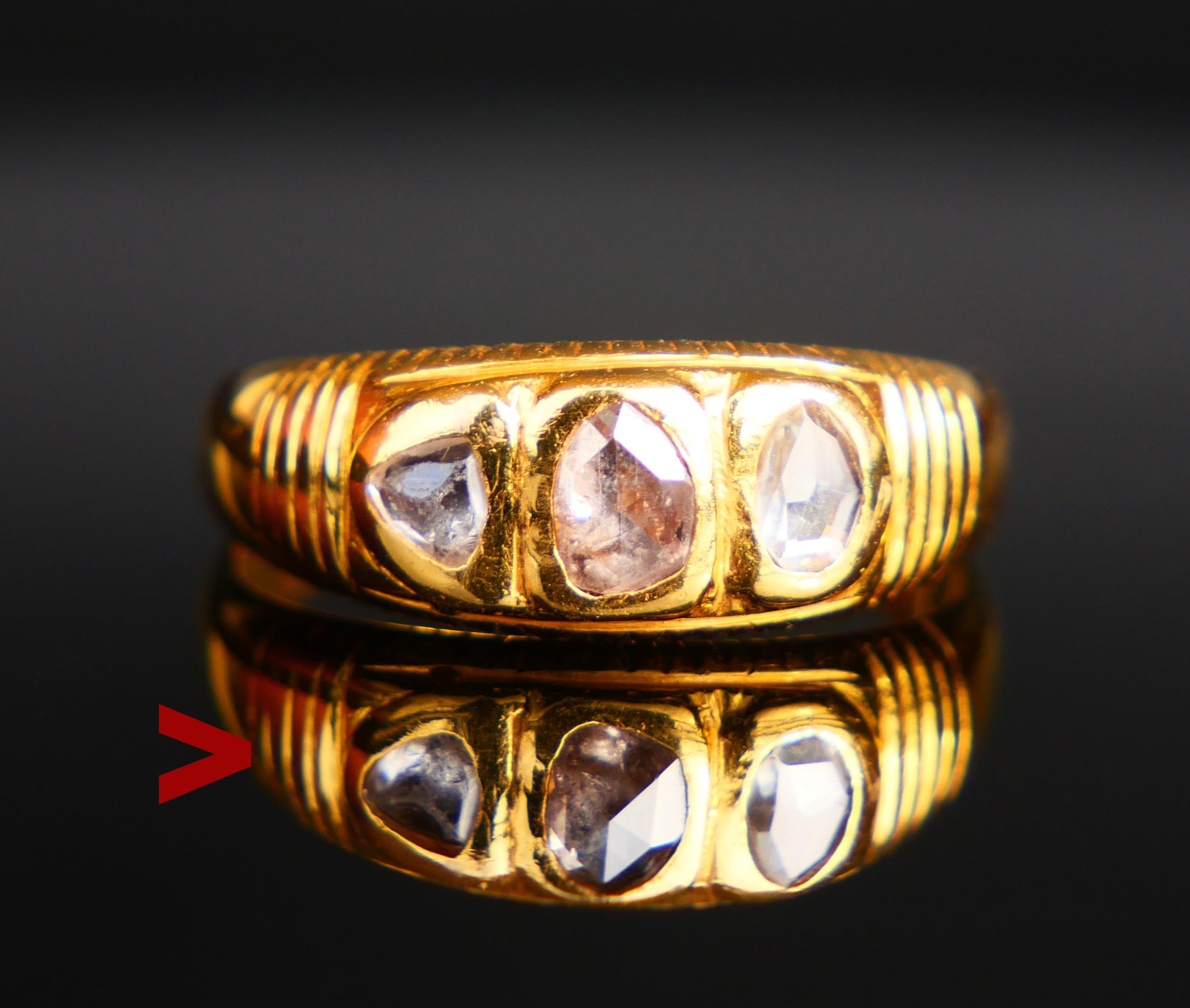 Аntique European solid 23K Ring with clusters holding 3 old rose hand-cut stones : two Diamonds and on Rock Quarts,all three rose cut. Metal was tested to be about 23K grade. No hallmarks.

That Quartz stone can be distinguished from two others