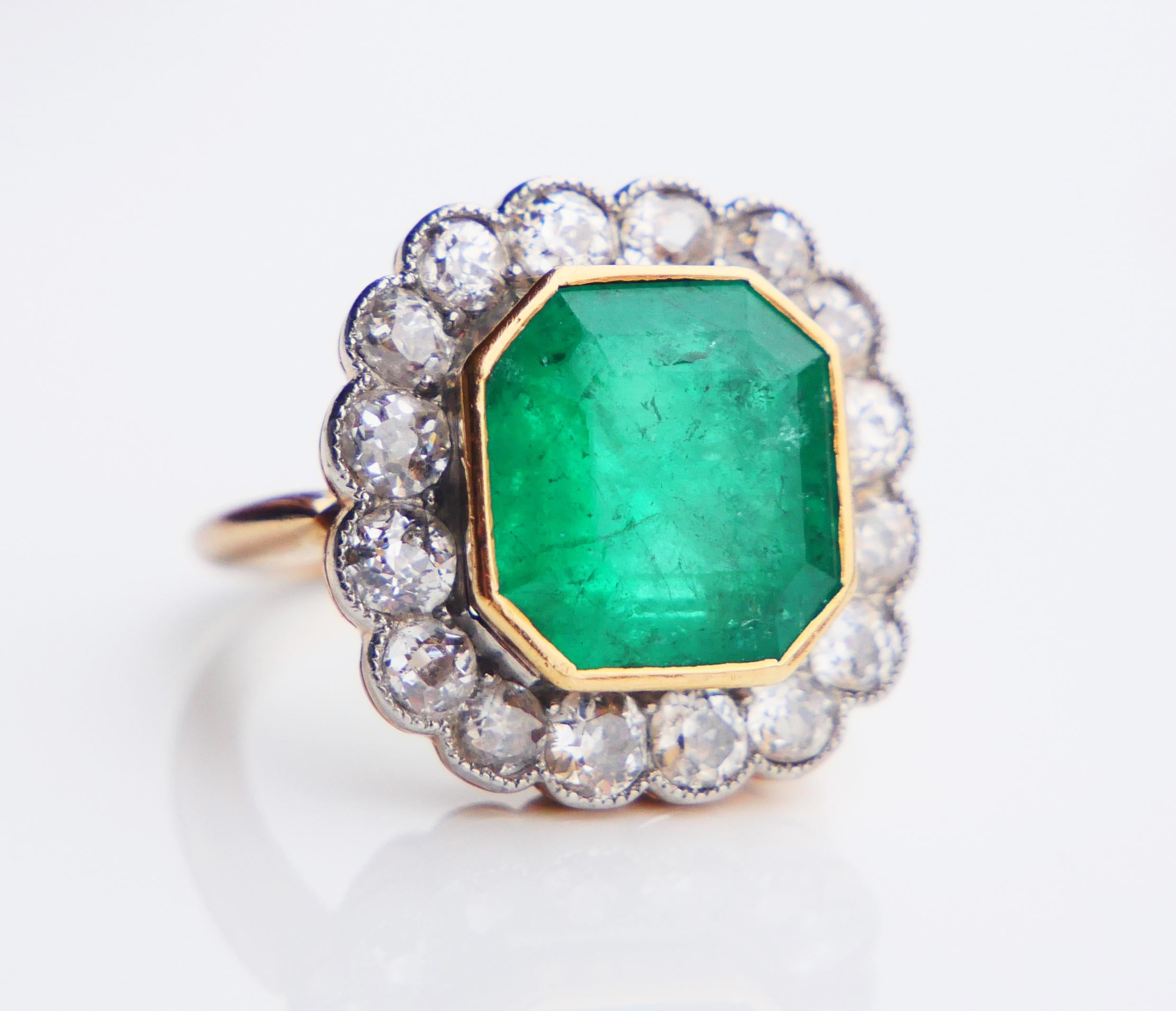 Emerald and Diamonds Ring with parts in solid 18K Yellow Gold and Platinum. Ca. 1930s -1940s, likely German Ring. No hallmarks 18K, metal tested solid 18K Yellow Gold.

Bezel set natural asscher cut Emerald stone of deep Green color 11 mm x 11 mm x