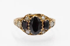 Antique ring with dark red zircons and natural pearls, Great Britain, 1909.