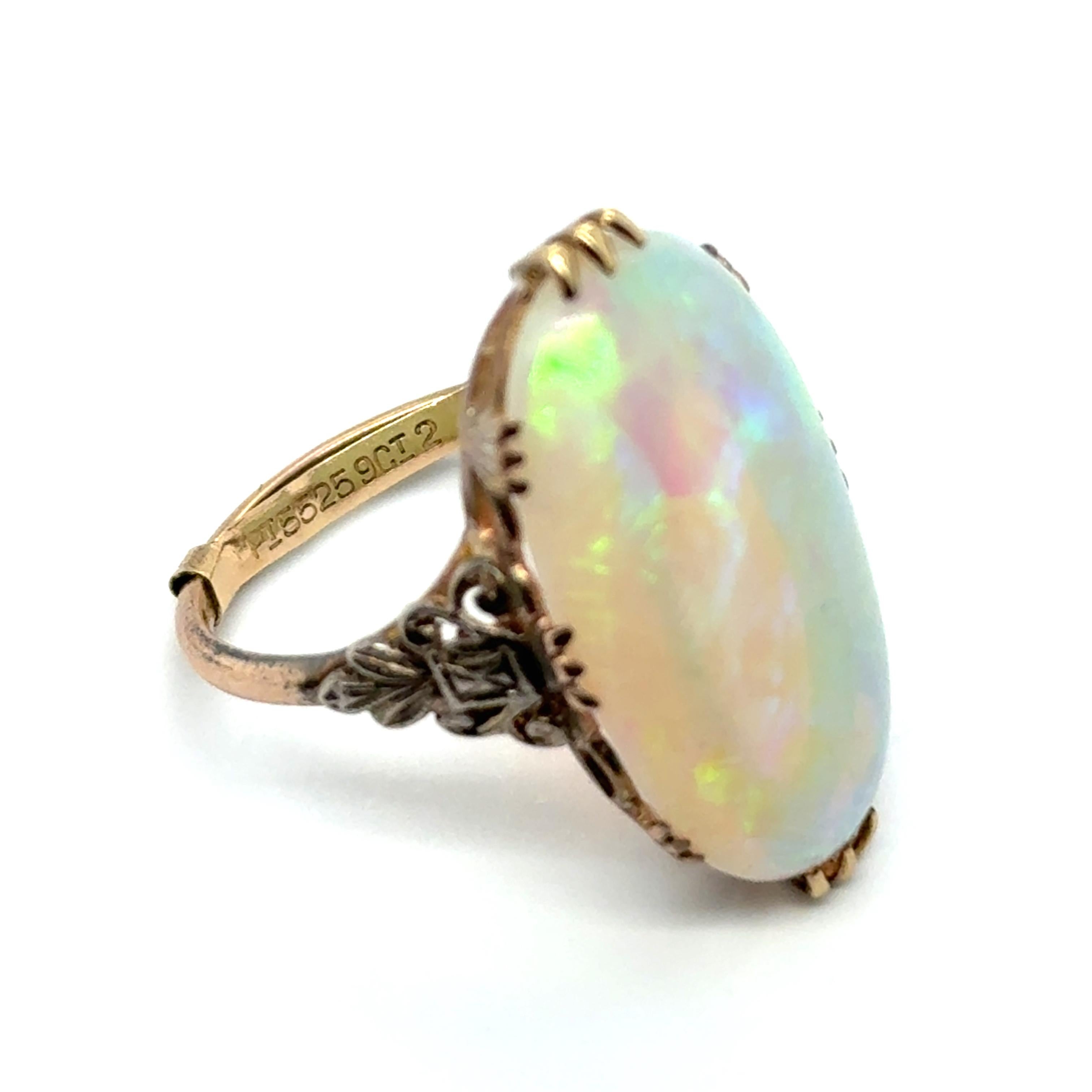 This enchanting antique ring, crafted in 9-karat yellow gold and silver, highlights a mesmerizing 8.00-carat white opal. 

Known for its captivating play of colours, the white opal symbolizes hope and purity, with shifting hues that evoke timeless