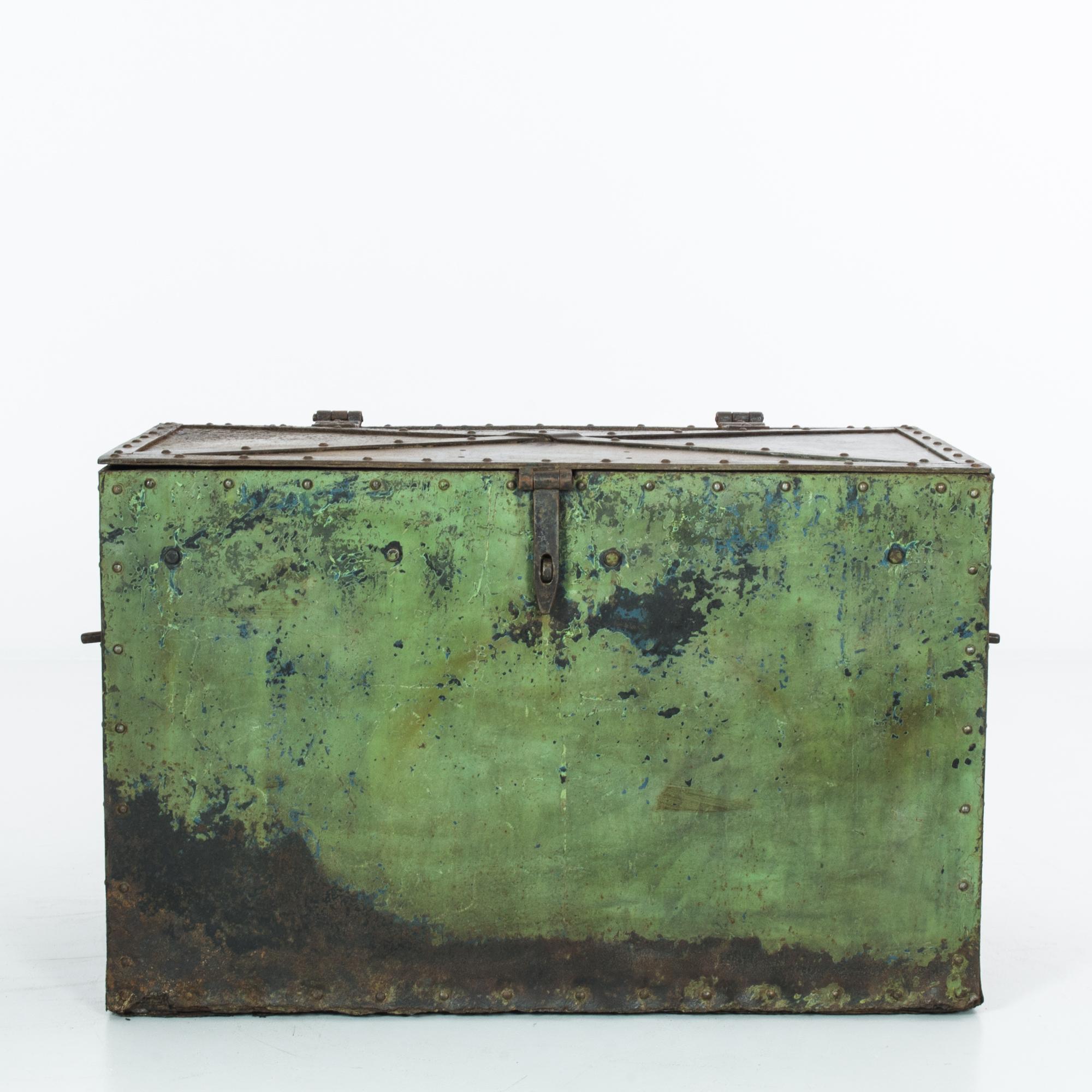 A metal trunk from Central Europe, produced circa 1900. A riveting old world antique, this metal trunk features its original hinges, handles, and hasp with a stunning oxidized patina layered with complimentary blue and green. A remarkable find, this