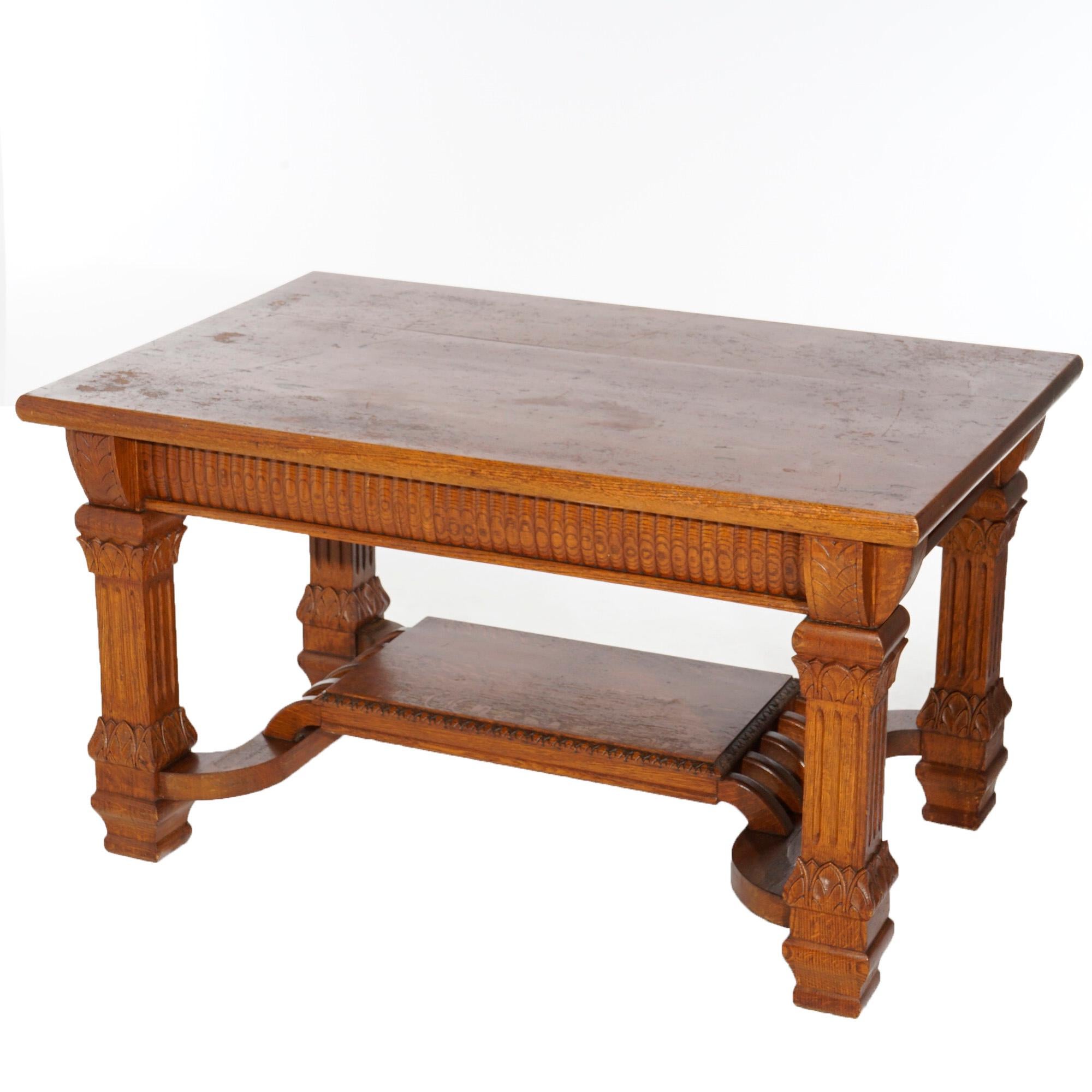 An antique library table in the manner of RJ Horner offers golden oak quarter sawn oak construction with top having reeded skirt and drawer, raised on square Corinthian column balustrade legs with acanthus elements and central raised shelf,