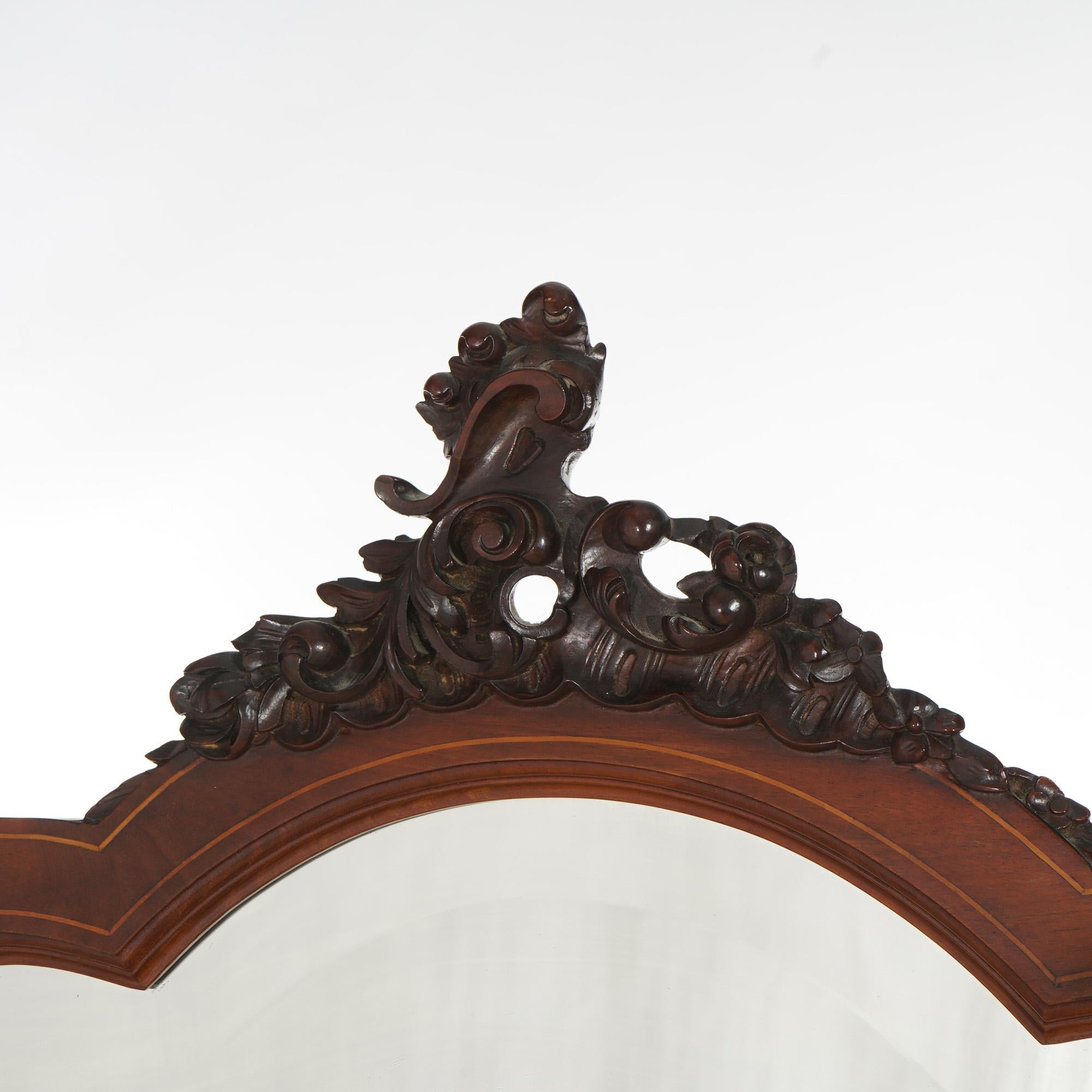 ***Ask About Reduced In-House Shipping Rates - Reliable Service & Fully Insured***
An antique cheval floor mirror in the manner of RJ Horner offers mahogany construction with shaped mirror having Rococo style carved cartouche over dressing mirror