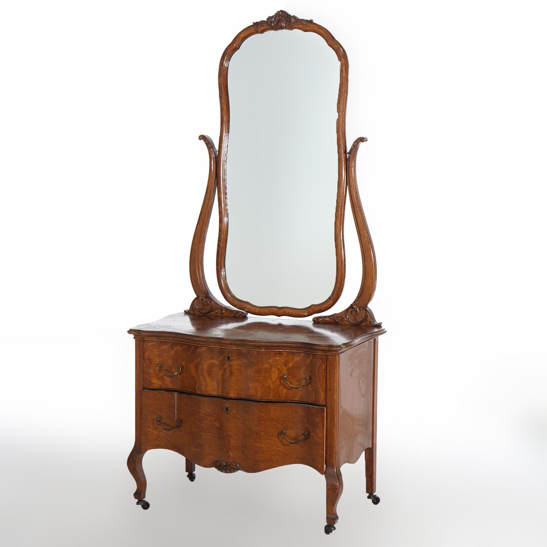 ***Ask About Reduced In-House Shipping Rates - Reliable Service & Fully Insured***
An antique princess dresser after RJ Horner offers oak construction with shaped dressing mirror over serpentine two drawer chest, c1920

Measures - Overall 69.5
