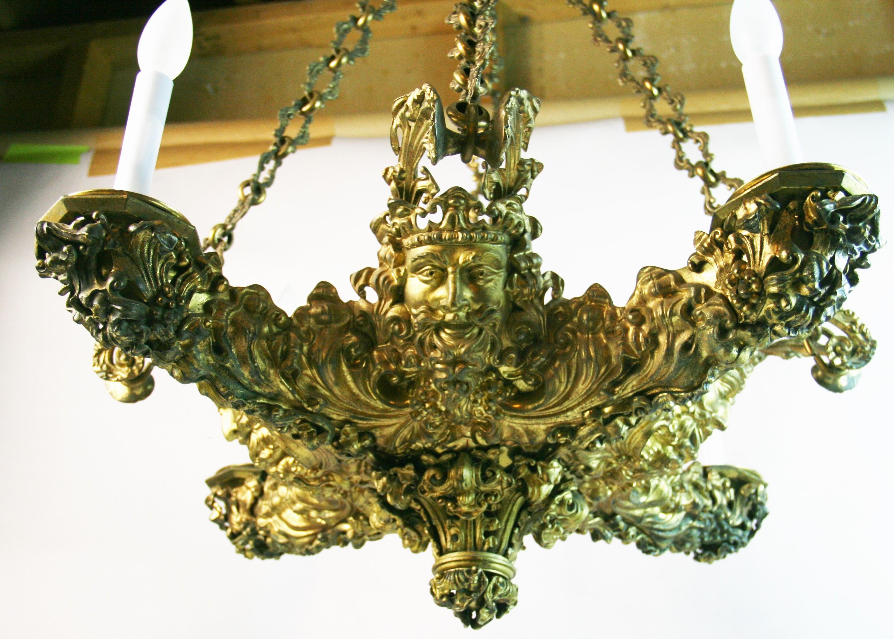 1845 Antique Rocco gilt bronze 4 light chandelier with elaborately detailed castings.
Rewires 
Takes 4 60 watt candelabra base bulbs
Can be wired with additional 4 light internal uplights
