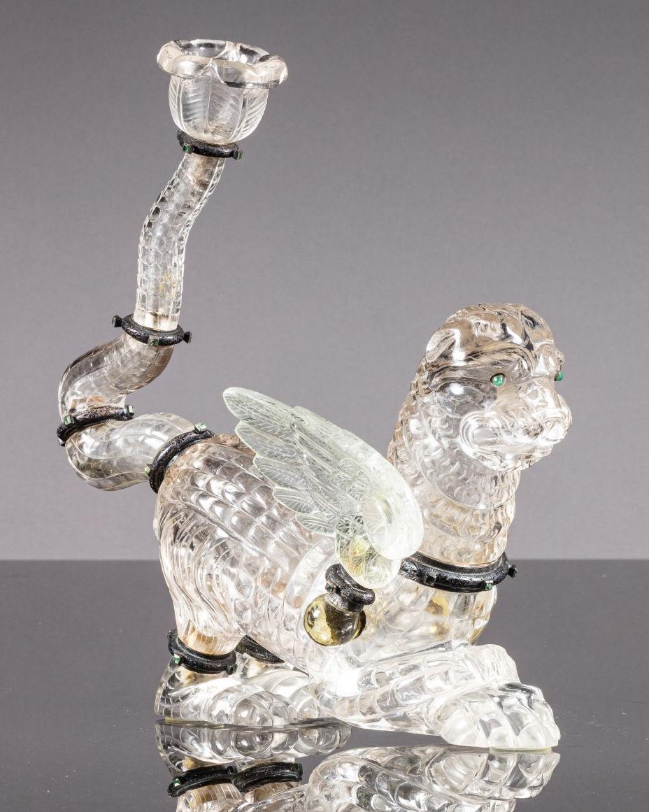 Our large, antique winged lion, known as a Chimera from Greek mythology, is exquisitely sculpted from rock crystal (quartz).  Likely of Austrian origin and dating from the late nineteenth century. Designed as a candlestick or flower holder, the