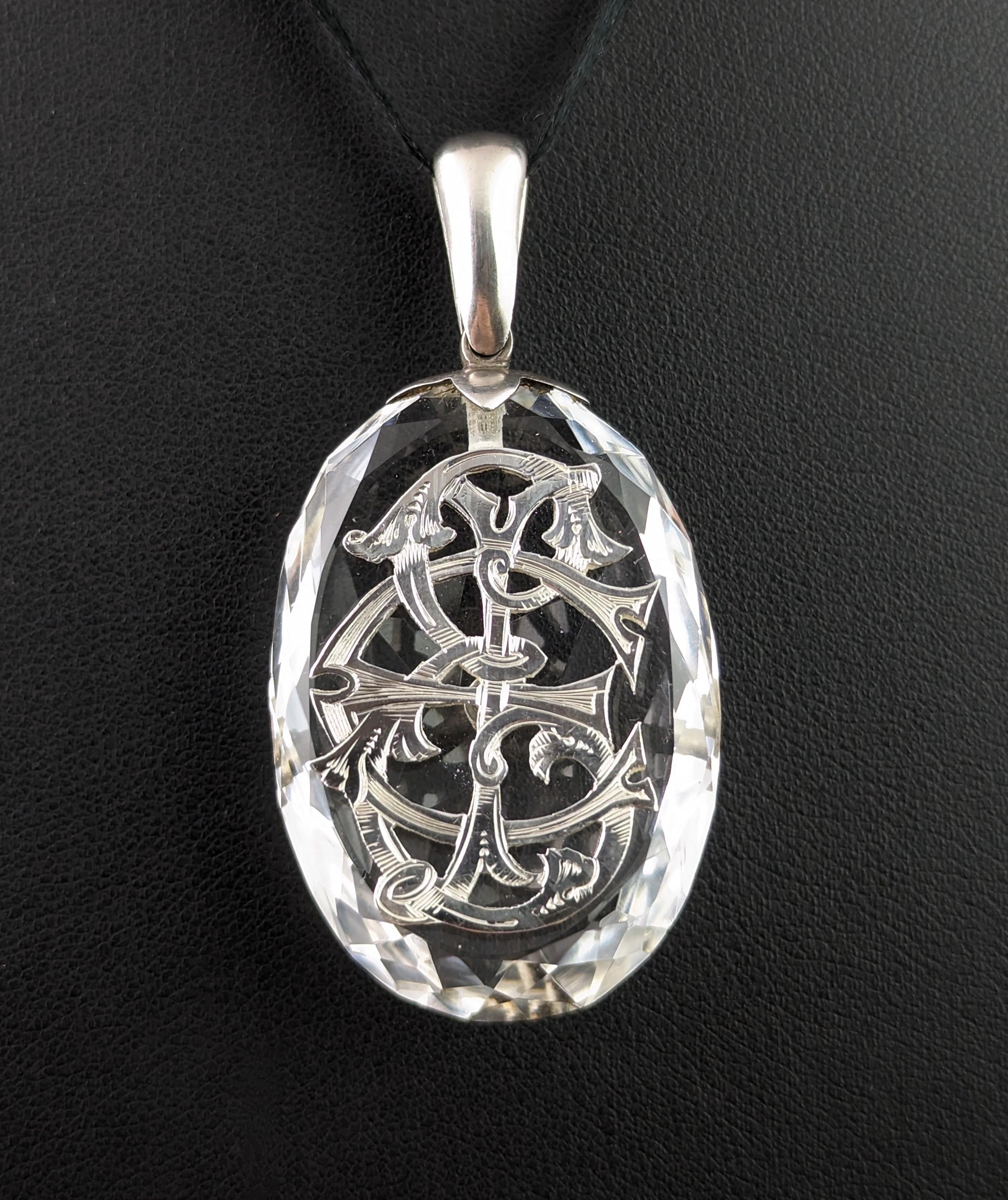 You can't help but be enchanted by this magical antique Rock crystal monogram pendant.

One of the most grand rock crystal pieces with the amazing and wonderfully faceted large oval shaped rock crystal embellished with a large sterling silver
