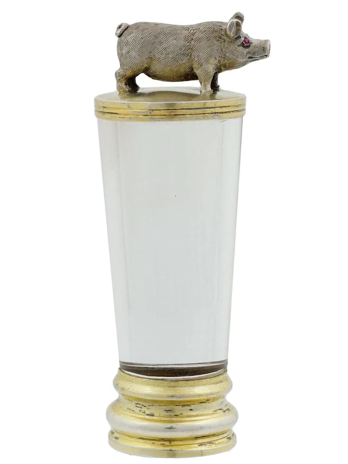 A hand seal. Clear glass body, gilt silver fittings. Figurative pig finial with gemstone eyes. Unmarked. Collectible Desk Accessories, Writing Instruments, Jewelry.
Dimensions: 3 x 1 in. All measurements are approximate.
Condition

Overall good