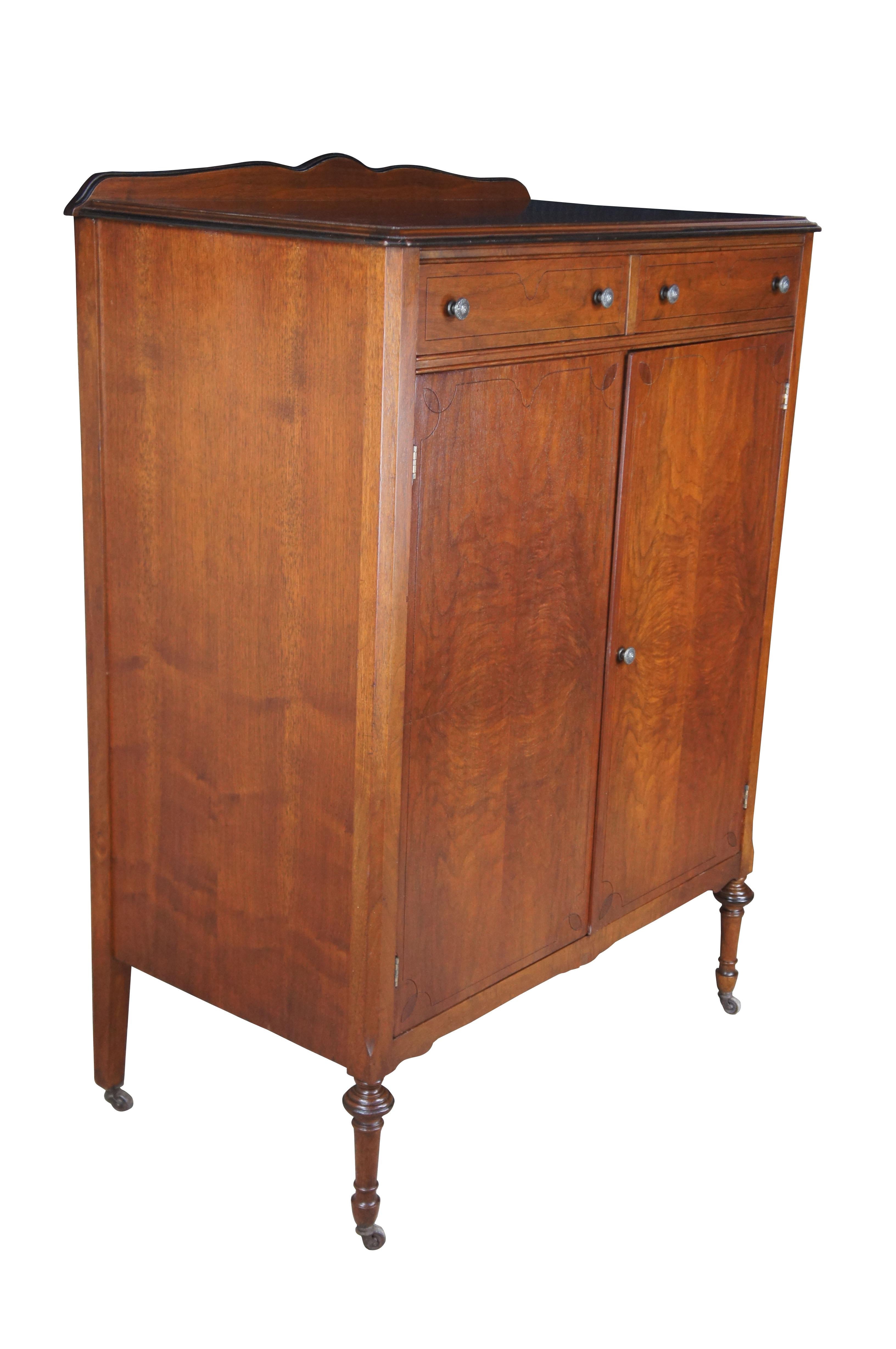 Rockford Furniture Art Deco Tallboy cheset of drawers, circa 1930s. Features a walnut frame with matchbook burled veneer along the front doors.  The chest has two smaller dovetailed drawers along the top and opens to 5 graduated interior drawers. 