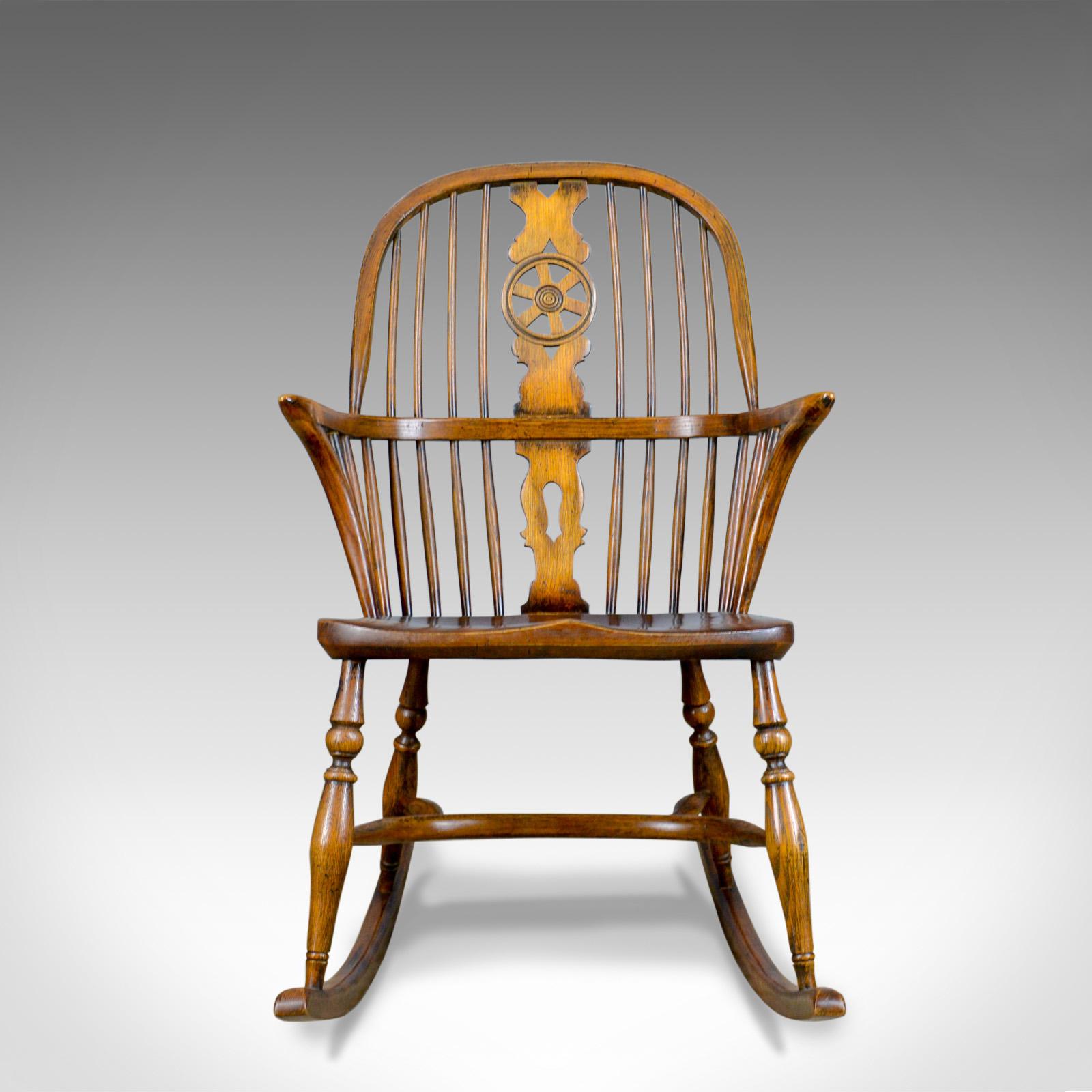 This is an antique rocking chair, an English Edwardian, Windsor, country kitchen, stick back elbow chair in elm, beech and ash dating to circa 1910.

Stunning chair in fine order throughout
Classic pierced back splat above and below the arm