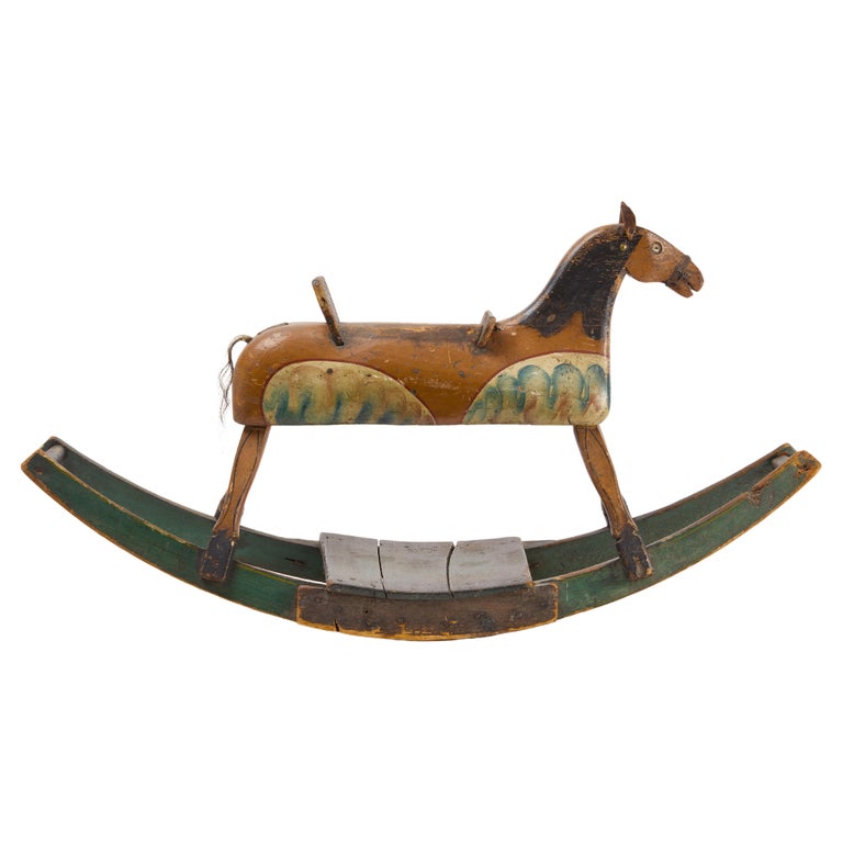 A beautifully carved and painted 19th century American toy rocking horse, with leather ears and horsehair tail, attributed to Benjamin Potter Crandall, American, circa 1850, retaining its original painted surface. Structurally very solid and paint